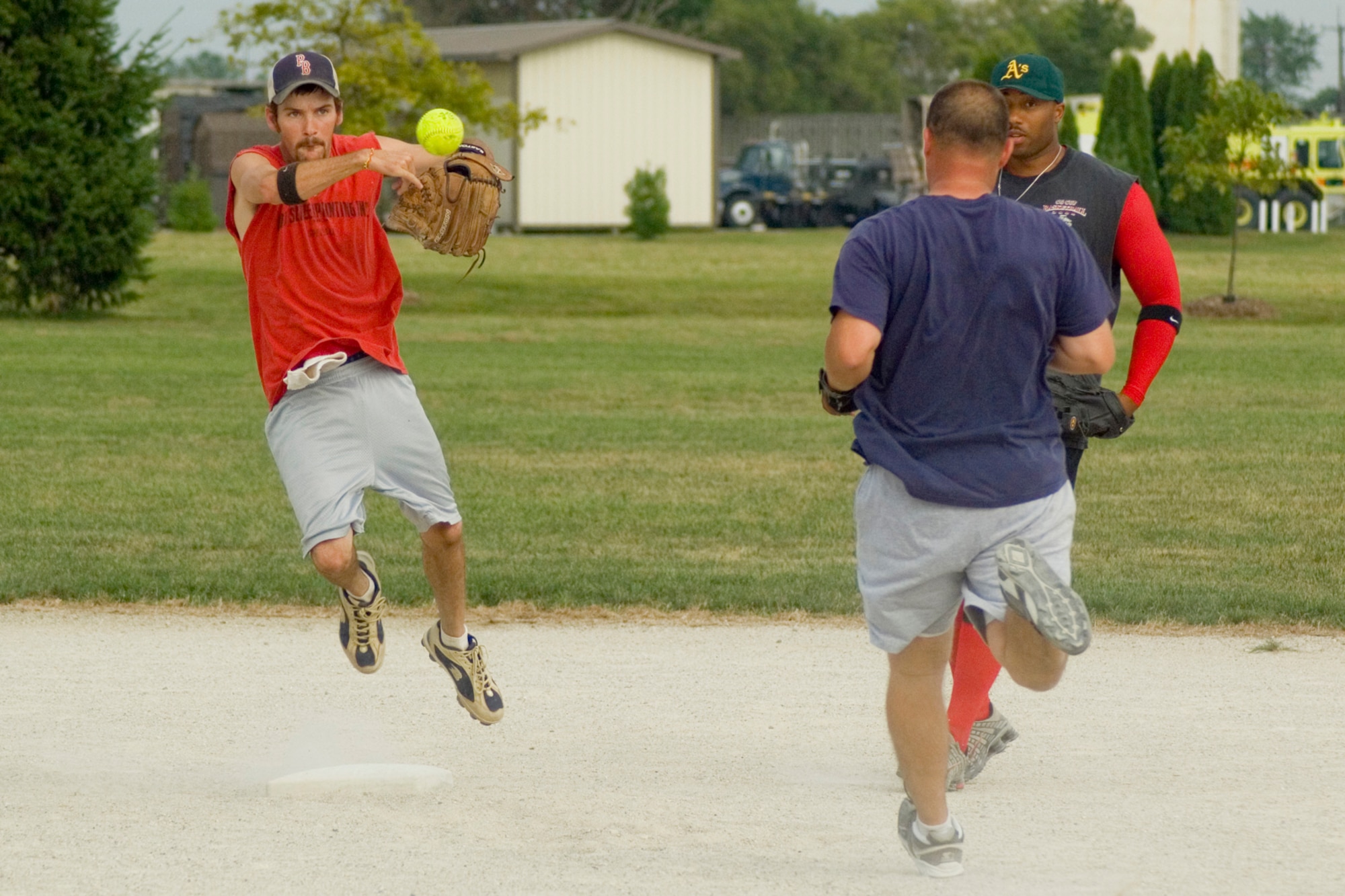 GRISSOM AIR RESERVE BASE, Ind., -- Jared Hayne, shortstop for the Marines, tries to turn a double play against the Grissom Fire Department during the intramural softball championship. The firemen's bats were blazing early in the game allowing them to get off to a hot start before cruising to a comfortable 16-9 win against the Marines.  (U.S. Air Force photo/Tech. Sgt. Douglas Hays)
