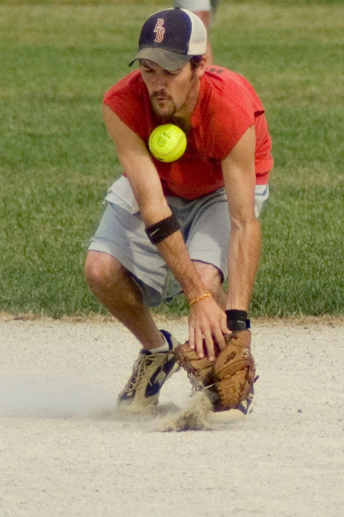 GRISSOM AIR RESERVE BASE, Ind., -- Jared Hayne, shortstop for the Marines, takes a bad hop off the chin during the final game of the intramural championship series. The Marines fell to the Grissom Fire Department 16-9 in the double elimination tournament. (U.S. Air Force photo/Tech. Sgt. Douglas Hays)