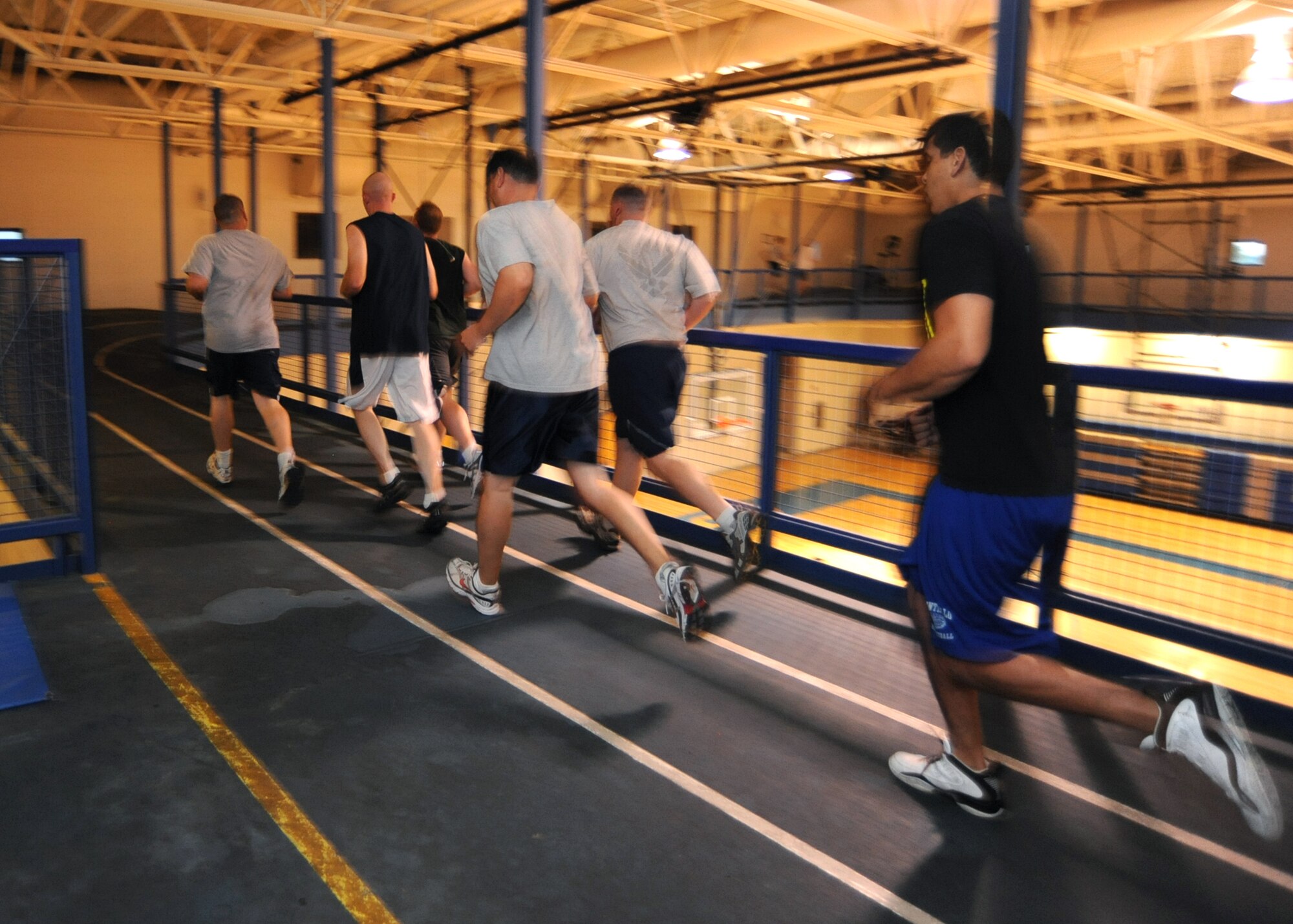 Team McConnell Airmen run for 20 minutes as part of the “Couch Potato to 5K” work out at the Robert J. Dole Community Center indoor track Aug. 27, 2010, McConnell Air Force Base, Kan.  The “Couch Potato to 5K” program meets three times a week for a nine-week work out plan of push-ups, sit-ups and alternating weekly running schedules.  The program is designed to gradually increase one’s running pace and encourage better physical fitness.  (U.S. Air Force photo/Senior Airman Maria Ruiz)