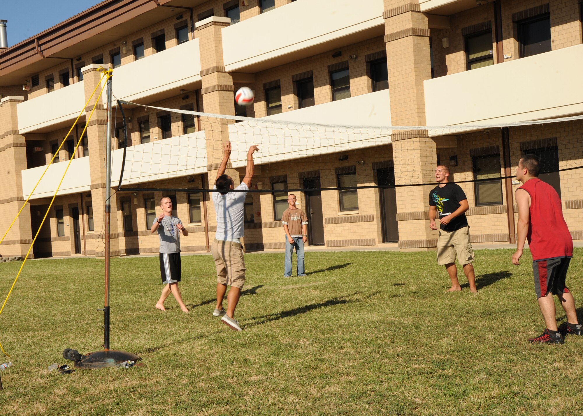 Team McConnell Airmen play volleyball during a dorm party at Building 342 Aug. 27, 2010, McConnell Air Force Base, Kan.  The party was hosted by dorm and floor chiefs to boost morale for Airmen living in the dorms.  The event featured free food, party games, a raffle drawing and an outdoor night movie.  (U.S. Air Force photo/Airman 1st Class Andrea Salazar)