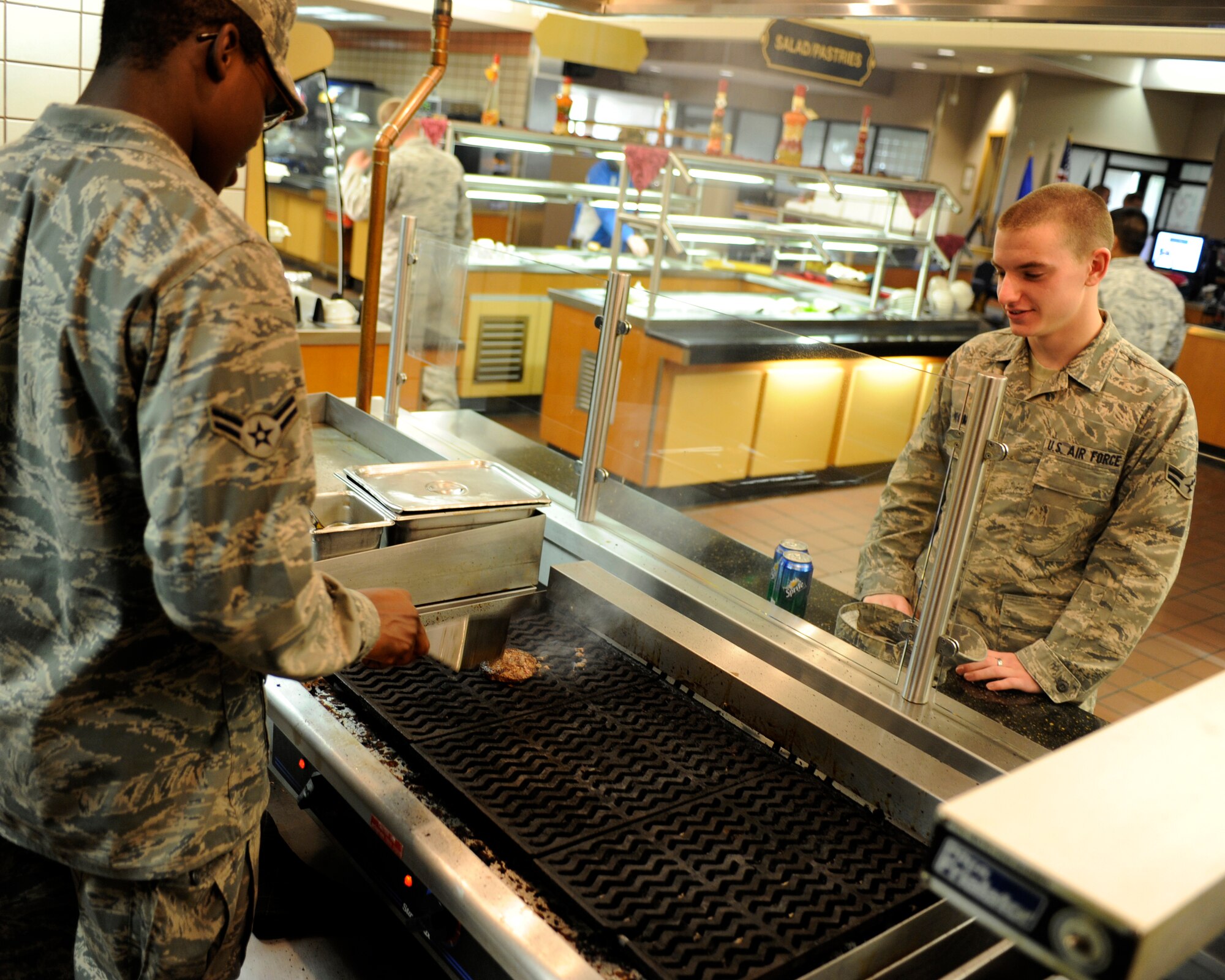 Airman 1st Class Andrew Clarke grills a burger for a customer August 31, 2010, Eielson Air Force Base, Alaska. The burgers are cooked to order to ensure maximum quality and freshness. Airman Clarke is assigned to the 354th Force Support Squadron. (U.S. Air Force photo/Senior Airman Willard E. Grande II)