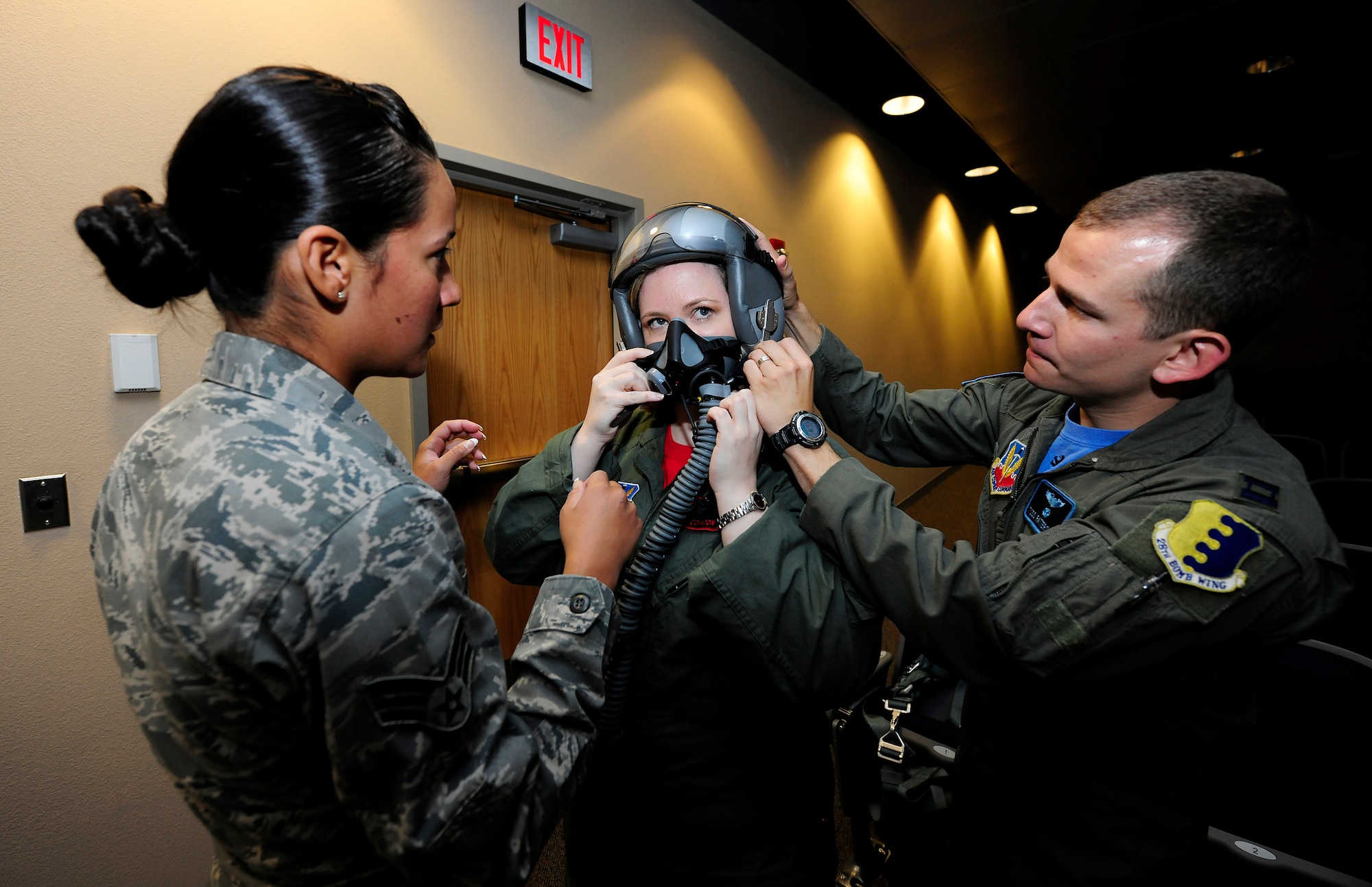 Senior Airman Jennifer Lopez, an aircrew flight equipment technician, and Capt. Todd Patterson, a wing aircrew flight equipment officer, help Under Secretary of the Air Force Erin Conaton, fit her life support equipment before she flew a B-1 Lancer mission Aug. 27, 2010, at Ellsworth Air Force Base, S.D.  The B-1 belonged to the 34th Bomb Squadron.  (U.S. Air Force photo/Scott M. Ash)