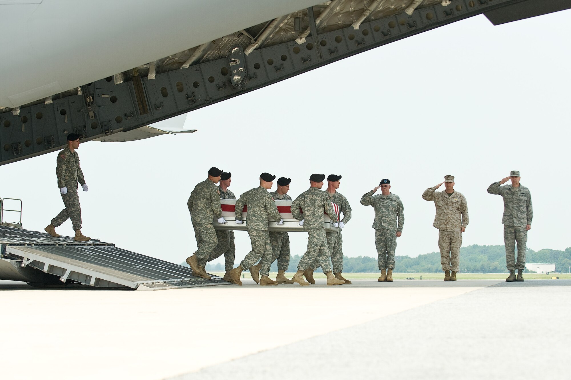A U.S. Army carry team transfers the remains of Army Sgt. Martin A. Lugo, of Tucson, Ariz., at Dover Air Force Base, Del., August 21. Sgt.Lugo was assigned to the 1st Battalion, 75th Ranger Regiment, Hunter Army Air Field, Ga. (U.S. Air Force photo/Roland Balik)