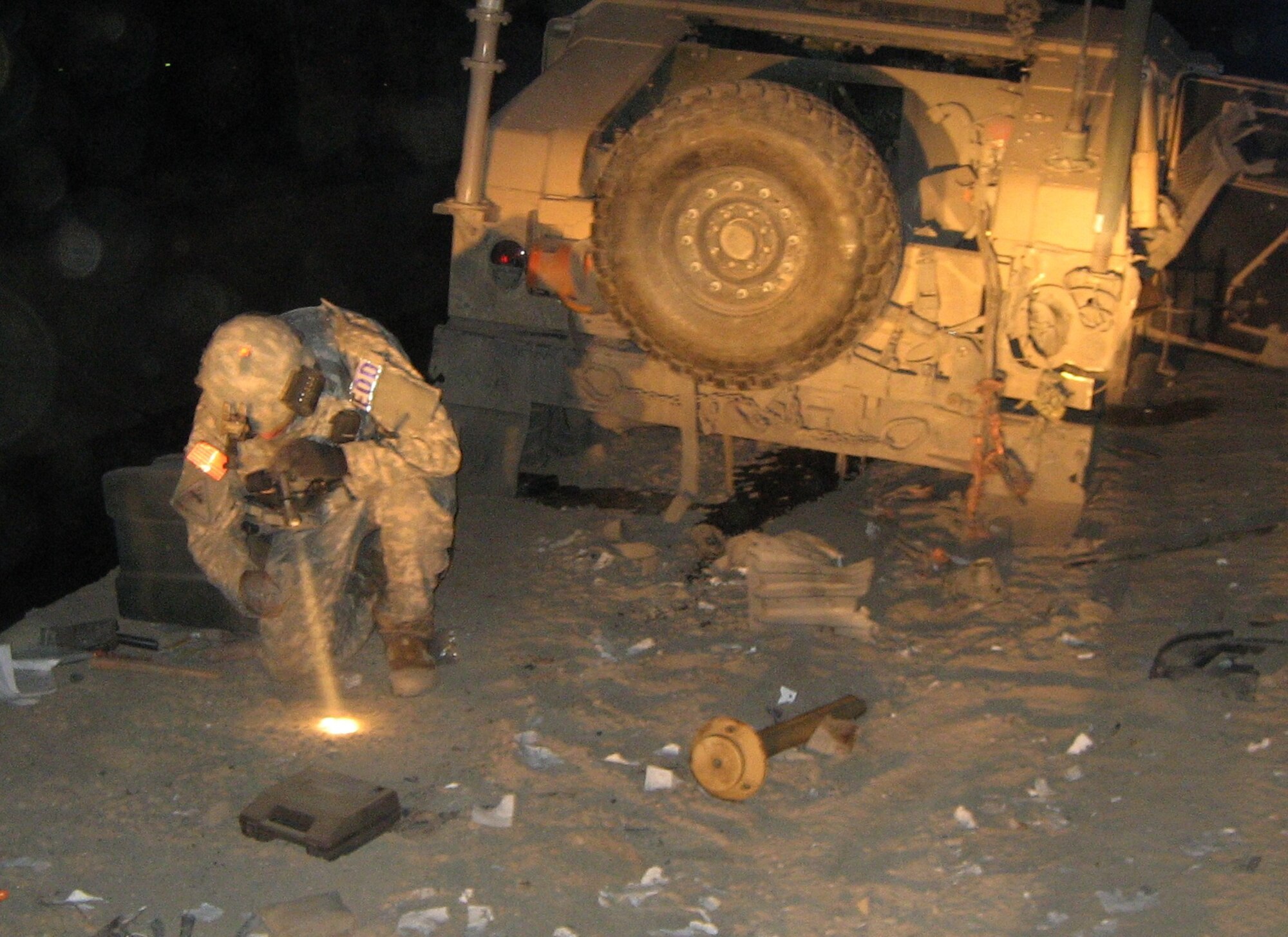 Technical Sgt. Peter Arbelo, 87th Civil Engineer Squadron explosion ordnance disposal technician, searches the scene of an improvised explosive device attack in Afghanistan for clues as to who made the device, what materials were used to make it and how it was detonated. While deployed, Arbello and fellow EOD technicians often respond to reports of IEDs targeted at convoys and use various tools such as robots to disable or detonate the devices. (Courtesy photo)