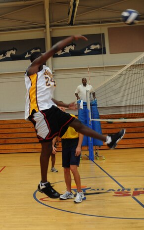 Jamel McCargo deflects the ball back to the 437th Aircraft Maintenance Squadron players during the first round of the intramural volleyball championship playoffs at the Fitness and Sports Center on Joint Base Charleston, S.C., Aug. 31, 2010. The 437 AMXS entered the playoffs as the second seed with a regular season record of 8-2. Their opponents, the 628th Communications Squadron, entered as the seventh seed with a record of 5-5. McCargo is with the 628 CS. (U.S. Air Force photo/Airman 1st Class Lauren Main)