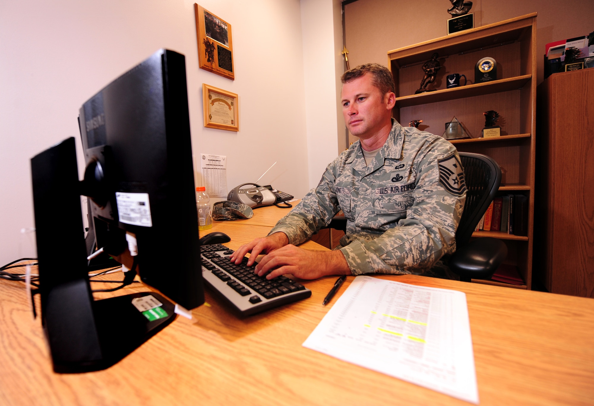 OFFUTT AIR FORCE BASE, Neb. - Master Sgt. Justin King, first sergeant for the 55th Wing staff, checks emails along with numerous other tasks in his office, located in building C, Aug. 25.  Sergeant King handles many administrative duties and administers corrective actions when necessary to members under the commander's authority. U.S. Air Force photo by Josh Plueger
