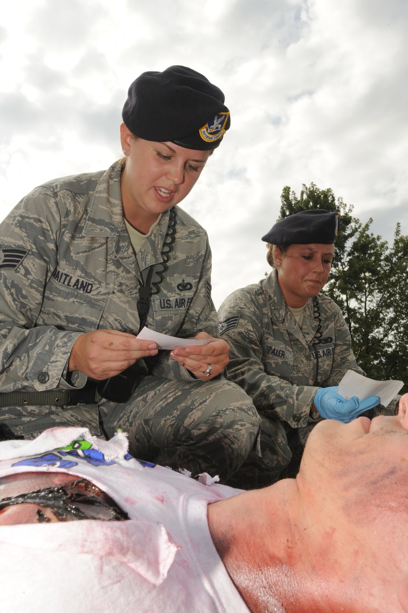 WHITEMAN AIR FORCE BASE, Mo. - Staff Sgt. Allison Maitland, 509th Security Forces Squadron law enforcement, aids a simulated aircraft accident victim during the major accident response exercise here, Aug.31. Whiteman conducted the MARE to prepare for the upcoming Wings Over Whiteman Air Show and Open House Scheduled for Sept. 18 and 19.(U.S. Air Force photo by Senior Airman Carlin Leslie)
	