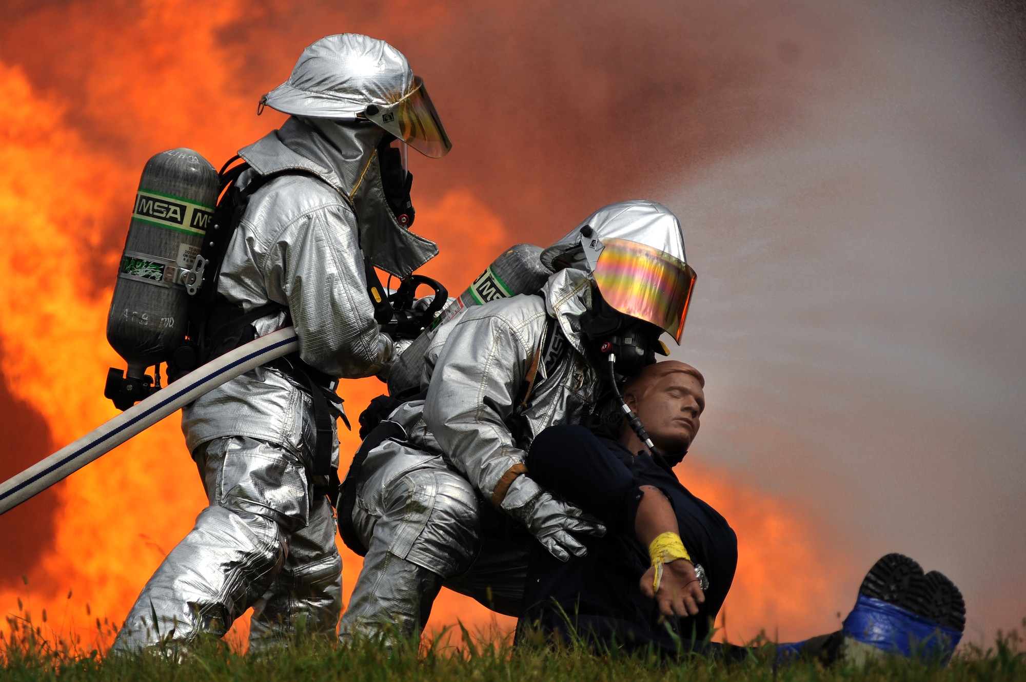 Firefighters from the 509th Civil Engineer Squadron work to extinguish a simulated aircraft fire and evacuate victims during a major accident response exercise, Aug. 31 at Whiteman Air Force Base Mo. Firefighters and other emergency response personnel conducted the MARE to prepare for any mishaps that may occur during the Wings Over Whiteman Air Show scheduled to take place Sept. 18 and 19. (U.S. Air Force photo by Senior Airman Kenny Holston)(Released)


