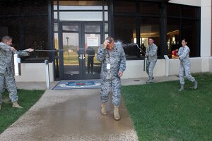 Col. Daniel R. Johnson, commander of the 480th Intelligence, Surveillance and Reconnaissance Wing, sat his final mission as an ISR mission commander in the Air Force Distributed Common Ground System Aug. 31 at Langley Air Force Base, Va.  Holding true to Air Force tradition, Colonel Johnson was hosed down in honor of his final mission, where he vectored ISR asset coverage in Afghanistan. Colonel Johnson is set to retire Sept. 9. (U.S. Air Force photo by Capt. Christopher Lohan)