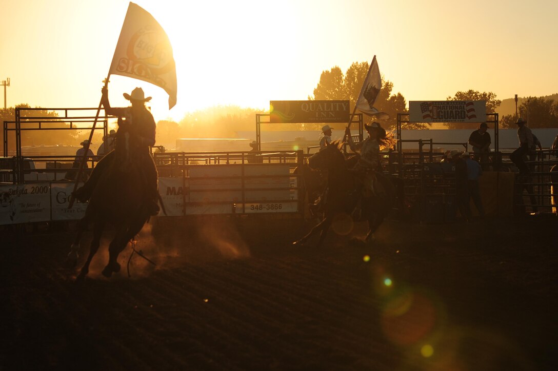 Cowgirls perform laps during military appreciation day at the Central States Fair Professional Rodeo Cowboys Association Range Days Rodeo in Rapid City, S.D., Aug. 26. Steer wrestling, tie down roping and barrel racing were performed at the rodeo. (U.S. Air Force photo/Senior Airman Corey Hook)

