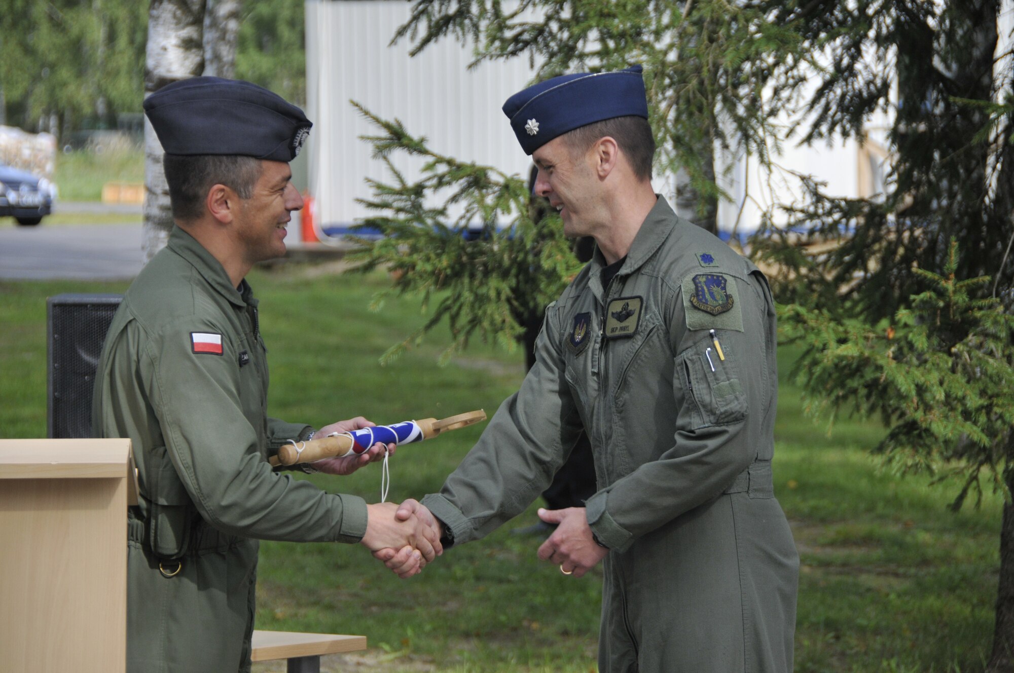 Lt. Col. Skip Pribyl (right), 493rd Expeditionary Fighter Squadron commander, accepts the "key" to the Baltic air space from Lt. Col. Robert Kozak, commander of the Polish air force detachment, at Lithuania Air Force Air Base on September 1, 2010. The key symbolizes the change of command from the Polish to American Air Force. The 493rd EFS will support this mission for four months. (U.S. Air Force photo/Tech. Sgt. Christopher Stagner)