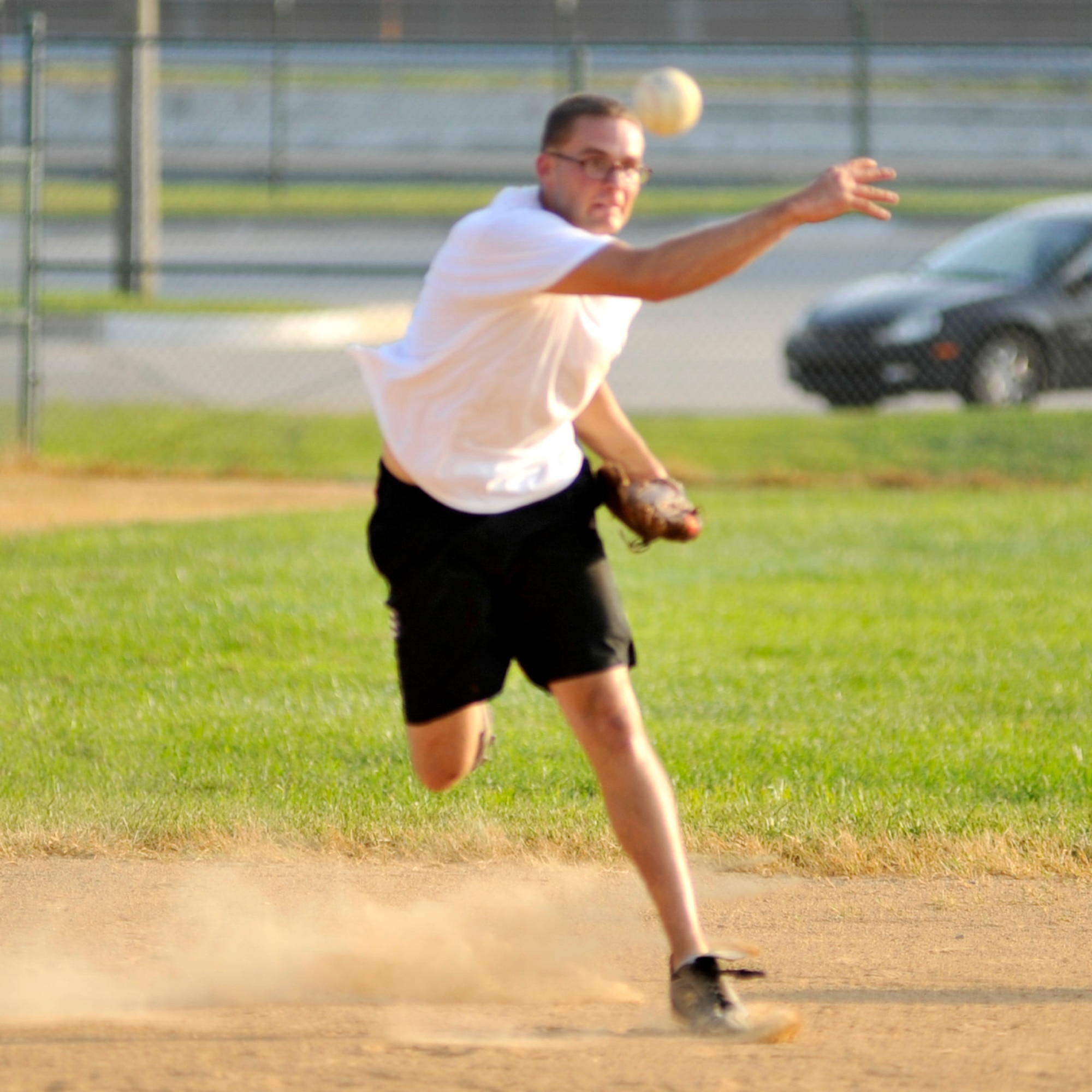 Shane Hierlmaier, 436th Maintenance Squadron third baseman, throws a runner out at first base during an intramural softball playoff game against the 436th Security Forces at the base softball field on Dover Air Force Base, Del., Aug. 31, 2010. MXS moved on to its third championship game in a row as it held off the Cops 11-10. (U.S. Air Force photo by Tech. Sgt. Chuck Walker/Released)