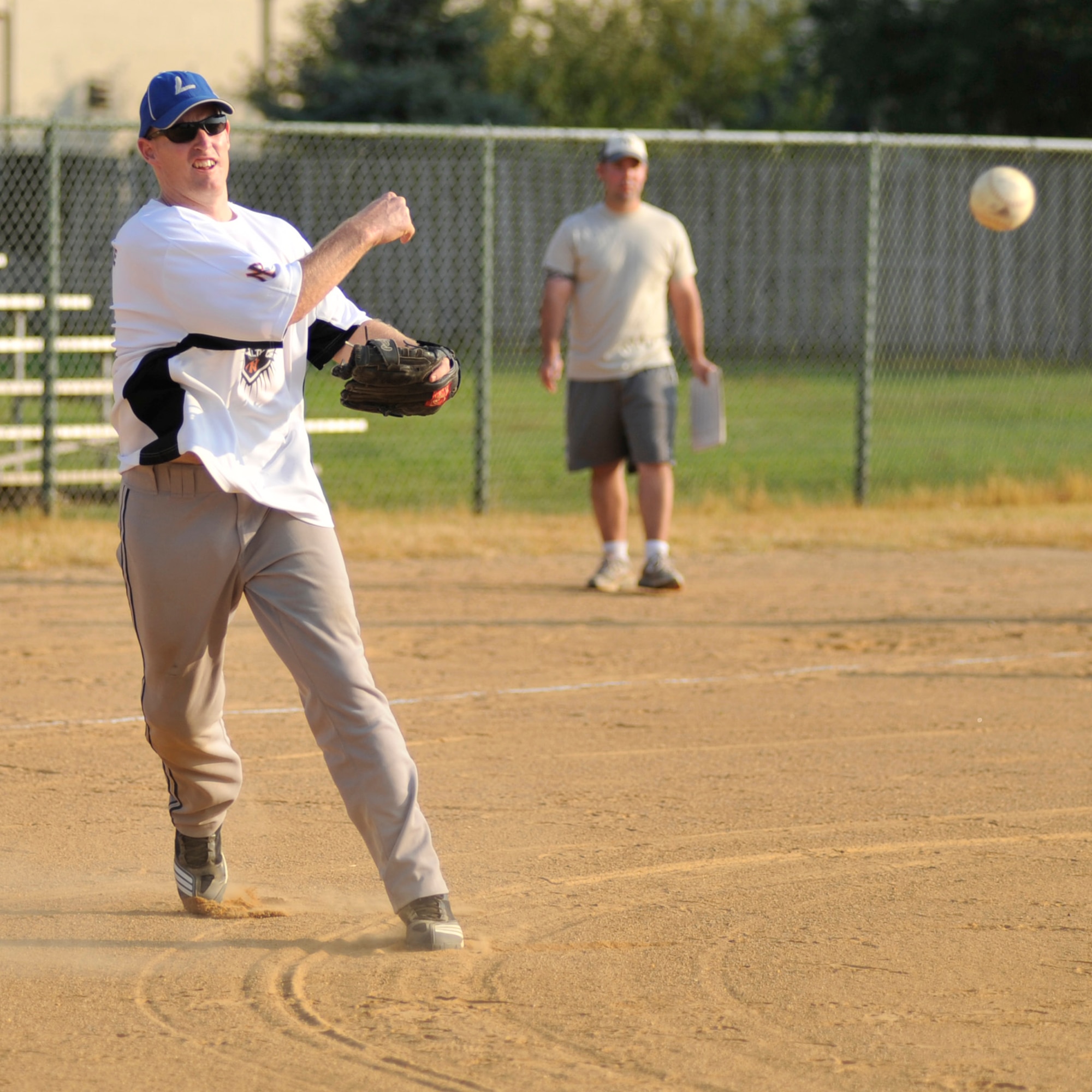Roger Parsons, 436th Maintenance Squadron pitcher, throws a runner out at first base during an intramural softball playoff game at the base softball field on Dover Air Force Base, Del., Aug. 31, 2010. MXS moved on to its third championship game in a row with an 11-10 victory against the 436th Security Forces Squadron. (U.S. Air Force photo by Tech. Sgt. Chuck Walker/Released)