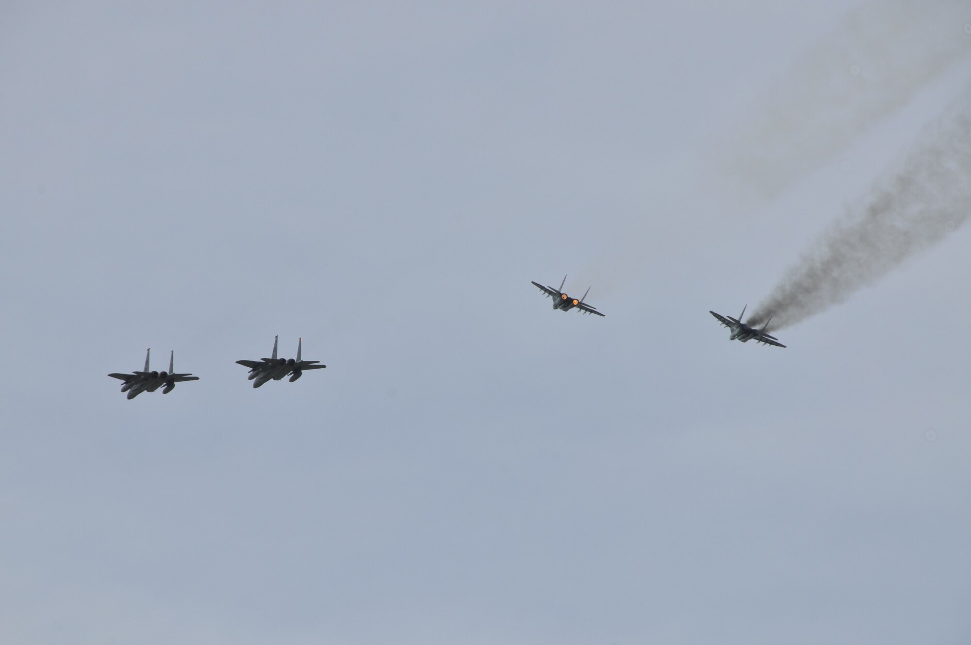 A flight of F-15Cs and MiG-29s fly over the airfield at Lithuania Air Force Air Base on September 1, 2010. The flight was symbolic of the 493rd Expeditionary Fighter Squadron assuming command of the Baltic air policing mission from the Polish air force. (U.S. Air Force photo/Tech. Sgt. Christopher Stagner)