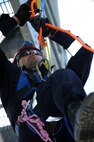 MINOT AIR FORCE BASE, N.D. -- Airman 1st Class Isaac Lazo, 5th Civil Engineer Squadron firefighter, descends the fire department training facility during an exercise here Aug. 24. Civilian firefighters from River Oakes, Ohio train base firefighters how to repel for “high and go” rope rescue scenarios, ascending, line changes and passing knots. (U.S. Air Force photo by Airman 1st Class Aaron-Forrest Wainwright)