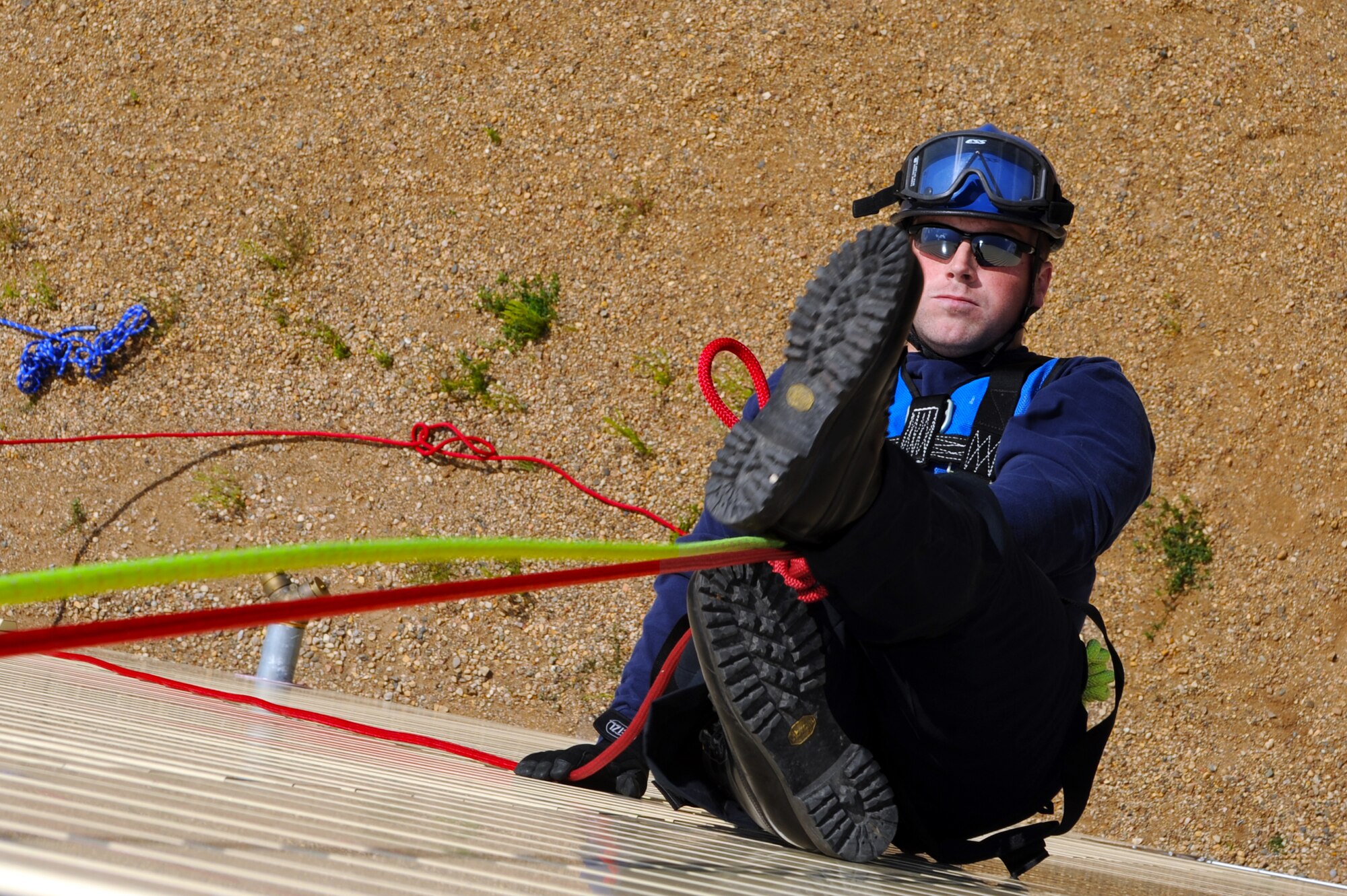 MINOT AIR FORCE BASE, N.D. -- Kristopher Doughty, 5th Civil Engineer Squadron firefighter, repels the fire department training facility during an exercise here Aug. 24. Civilian firefighters from River Oakes, Ohio train base firefighters how to repel for “high and go” rope rescue scenarios, ascending, line changes and passing knots. (U.S. Air Force photo by Airman 1st Class Aaron-Forrest Wainwright)
