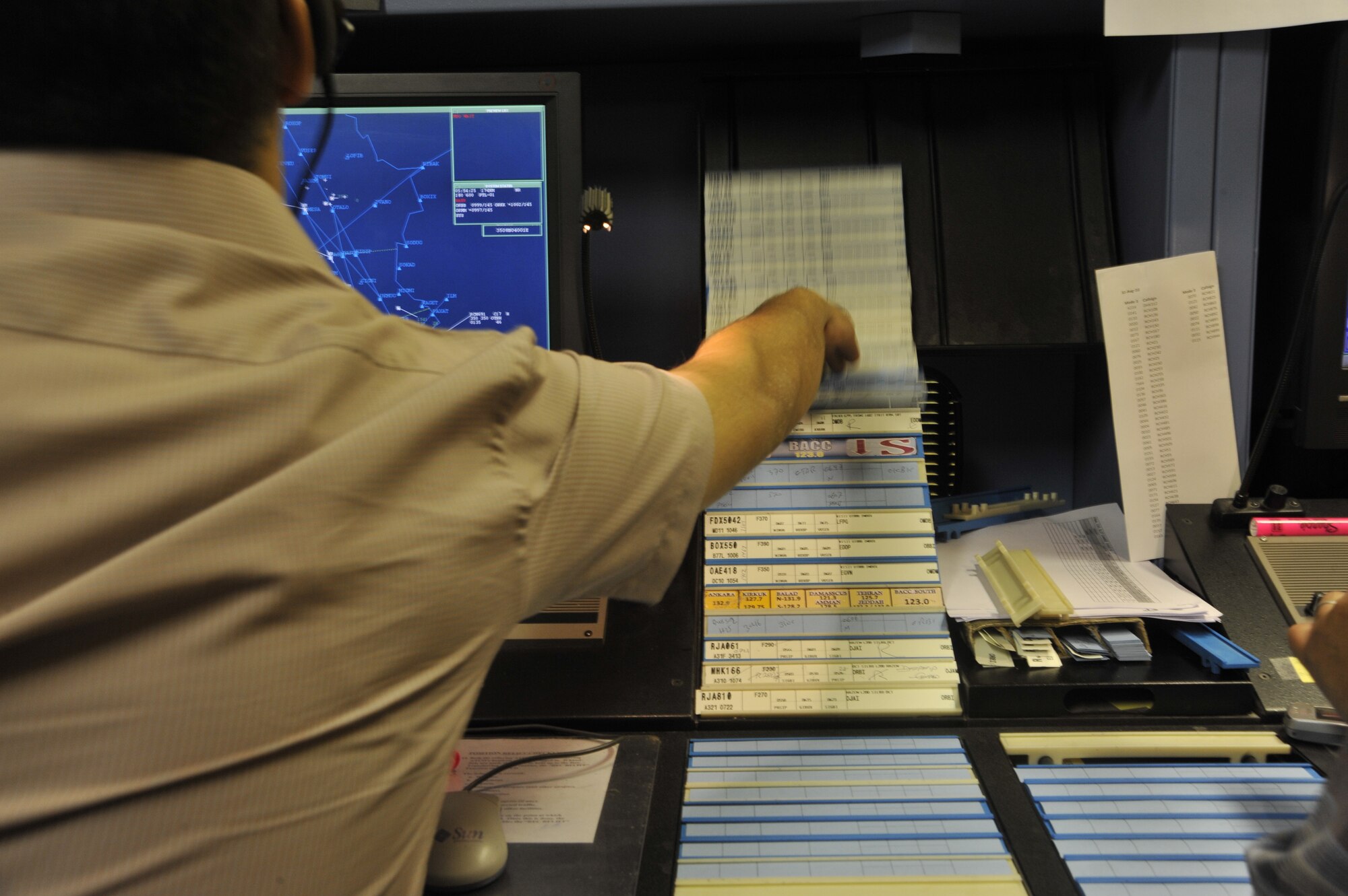 An Iraq Civil Aviation Authority air traffic control student moves flight progress strips in order of importance on the strip board, Aug. 31, 2010, at Baghdad International Airport, Iraq. With help from the Air Component Coordination Element - Iraq and the Washington Consulting Group, the U.S. Air Force is turning over airspace control from 15,000 to 24,000 feet in the northern sector of Iraq-known as the Kirkuk sector. (U.S. Air Force photo by Senior Airman Perry Aston) (Released)