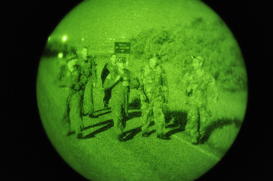 SOMEWHERE IN THE TURTLE MOUNTAINS, N.D. -- Aircrew members of the 54th Helicopter Squadron practice evasion techniques during night operations as part of a two-day survival, evasion, resistance and escape refresher course here Aug. 25. The course, led by Staff Sgt. Brett Sipe, 5th Operations Support Squadron base SERE instructor, focused only on the evasion and survival portions of the training. (U.S. Air Force photo by Senior Airman Benjamin Stratton)