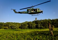 SOMEWHERE IN THE TURTLE MOUNTAINS, N.D. -- Aircrew members of the 54th Helicopter Squadron practice extraction techniques as they are hoisted to a UH-1N Huey during a two-day survival, evasion, resistance and escape refresher course here Aug. 25. The course, led by Staff Sgt. Brett Sipe, 5th Operations Support Squadron base SERE instructor, focused only on the evasion and survival portions of the training. (U.S. Air Force photo by Senior Airman Benjamin Stratton)