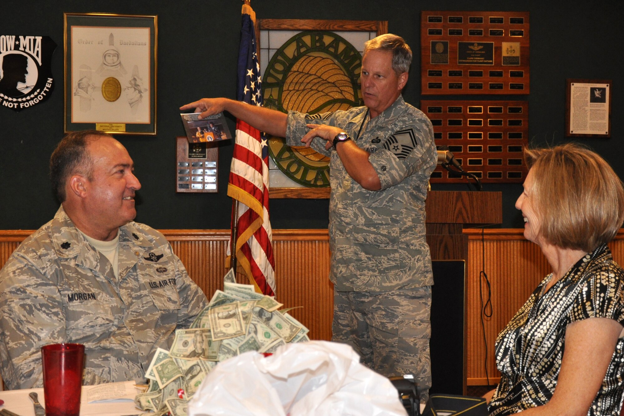 Senior Master Sgt. Dave Roberts, chief of education and training for the 917th Wing, presents a photo to Lt. Col. Charlie Morgan, as his wife Jeanne looks during his farewell luncheon at Barksdale Air Force Base, La., Aug. 27, 2010. Colonel Morgan, process manager for the 917th Wing, is retiring this month after 34 years of both military and civilian service to his country. One of the highlights of Col. Morgan’s military career was from 1984-86 during his time flying the advanced long range, Mach 3+, strategic reconnaissance aircraft, SR-71 “Blackbird” or “Habu” as it is affectionately known by its crews. A colorful figure at the 917th Wing for the past 23 years, Col. Morgan plans to spend more time enjoying his three children’s college years with his wife Jeanne during his retirement years. (U.S. Air Force photo/Tech. Sgt. Jeff Walston)