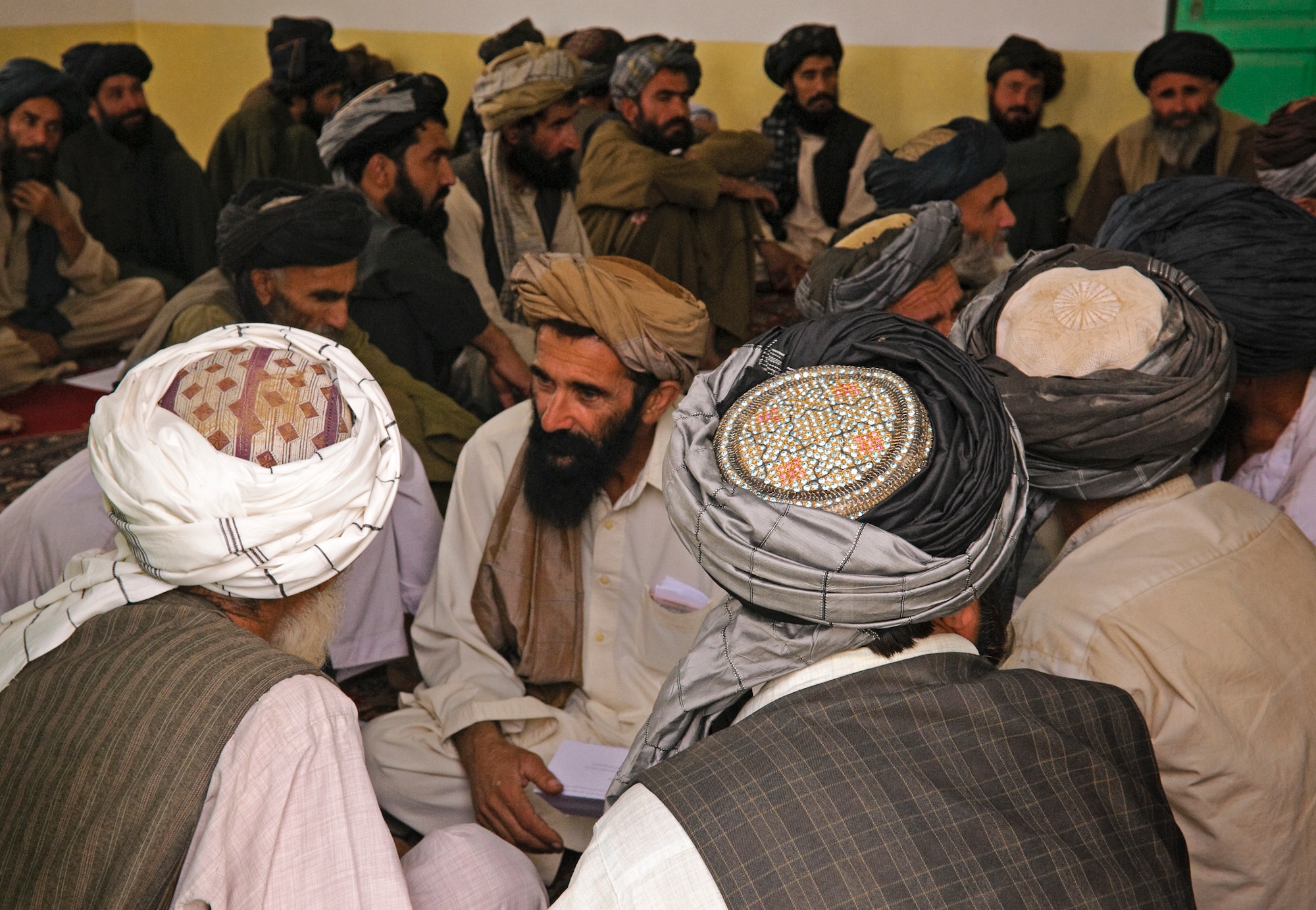COMBAT OUTPOST MIZAN, Afghanistan - Afghan elders listen to district officials during a shura at the Mizan District Center, Mizan District, Zabul province, Aug. 28. Mizan District officials invited local elders to the shura to discuss the upcoming provincial parliamentary elections and vote on a district manager. (U.S. Air Force Photo/Senior Airmen Nathanael Callon/Released) 