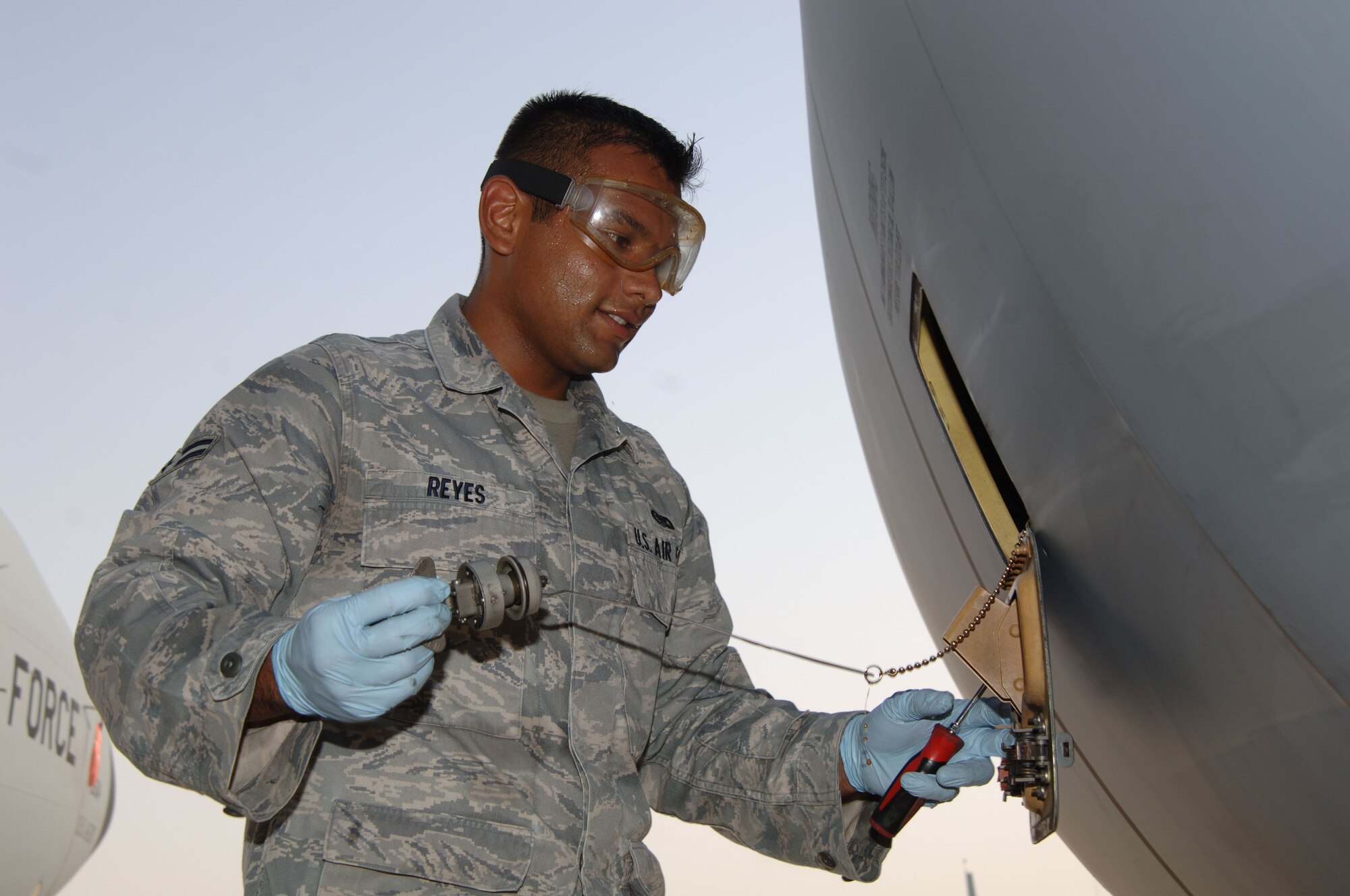 SOUTHWEST ASIA -  Airman 1st Class Alex Reyes, 379th Expeditionary Aircraft Maintenance Squadron, checks the oil of a KC-135 Stratotanker Sept. 1, 2010 at an undisclose location. The aircraft, flown by 340th Expeditionary Air Refueling Squadron Airmen, completed their last mission of operation IRAQI FREEDOM and the first of operation NEW DAWN. (U.S. Air Force photo/Tech. Sgt. Kimberly Spinner)