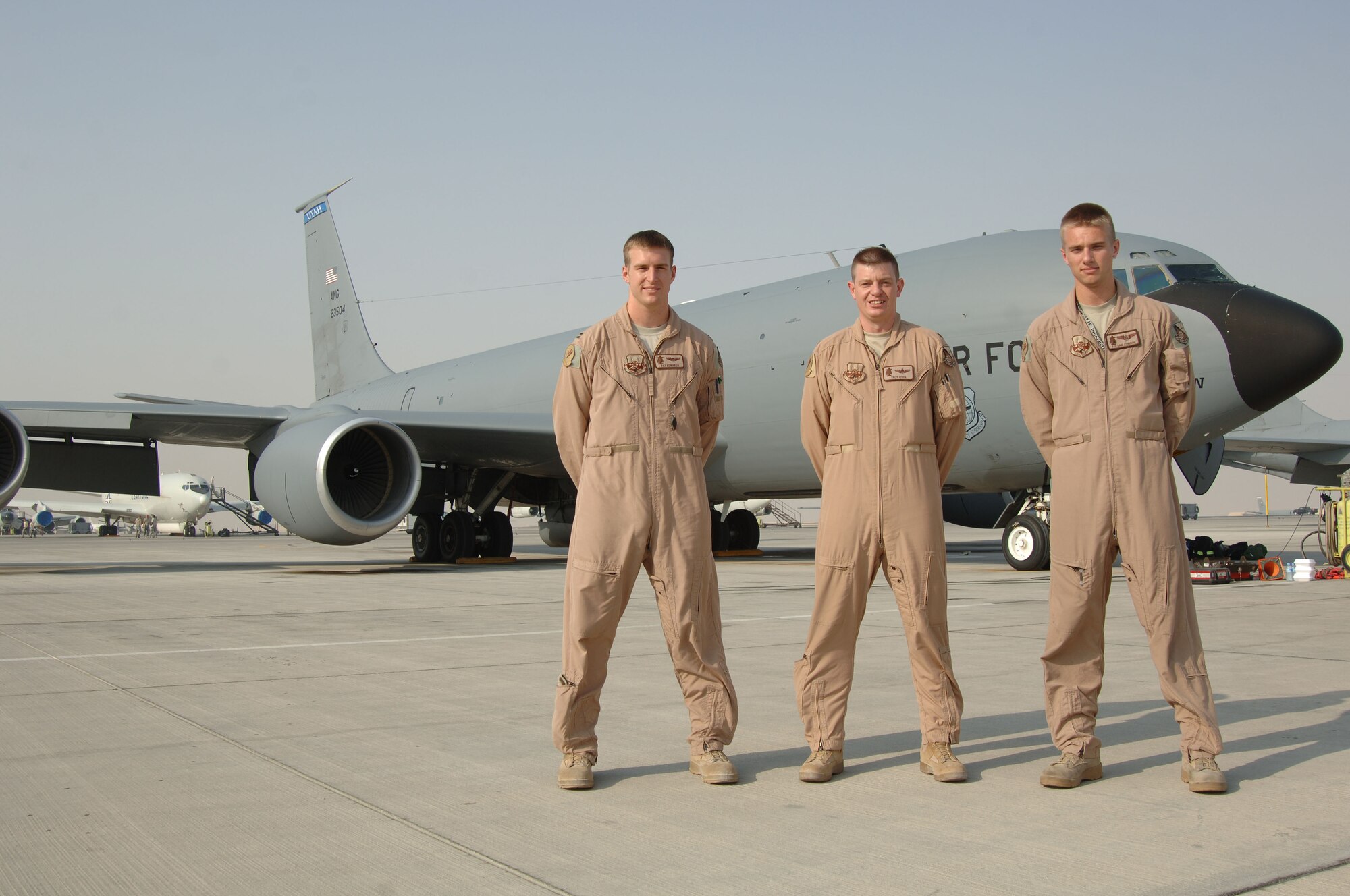 SOUTHWEST ASIA -  (From left to right) Capt. Pat Edwards, Maj. Troy Wing and Airman 1st Class Sam Johnson, KC-135 crew from McConnell Air Force Base, Kan., pose for a photo after completing a mission Sept. 1, 2010. This was the 379th Expeditionary Air Refueling Squadron's last sorte of operation IRAQI FREEDOM and the first of operation NEW DAWN. (U.S. Air Force photo/Tech. Sgt. Kimberly Spinner)