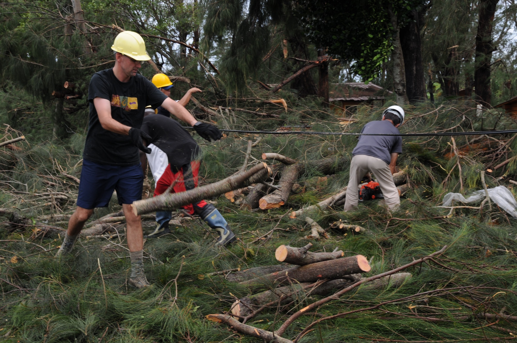 Staff members of the Okuma Resort remove debris from the main road after Typhoon Kompasu Aug. 31, 2010. Typhoon Kompasu slammed into the Okuma Recreation Area in northern Okinawa and is closed until further notice. (U.S. Air Force photo/Staff Sgt. Darnell T. Cannady)