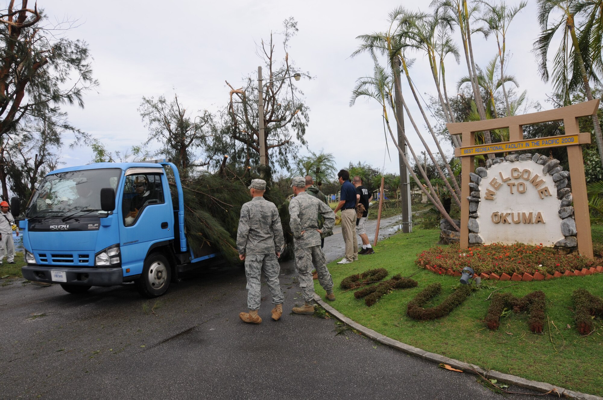 Members of the 18th Civil Engineering Squadron move as a truck filled with debris caused by Typhoon Kompasu leaves the Okuma resort Aug. 31, 2010. Typhoon Kompasu slammed into the Okuma Recreation Area in northern Okinawa and is closed until further notice. (U.S. Air Force photo/Staff Sgt. Darnell T. Cannady)
