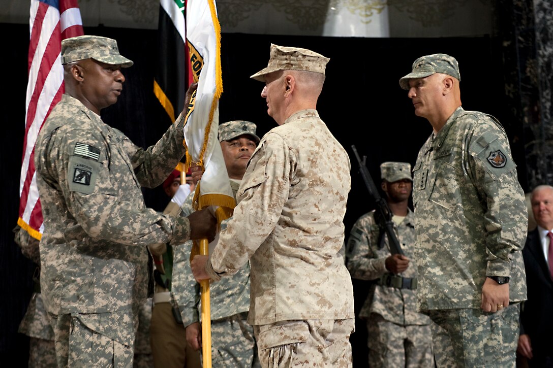 U.S. Army Gen. Lloyd J. Austin III, commander, U.S. Forces Iraq, receives the command colors from U.S. Marine Gen. James N. Mattis, commander, U.S. Central Command, at the change-of-command ceremony for U.S. Forces Iraq in Baghdad, Sept. 1, 2010.