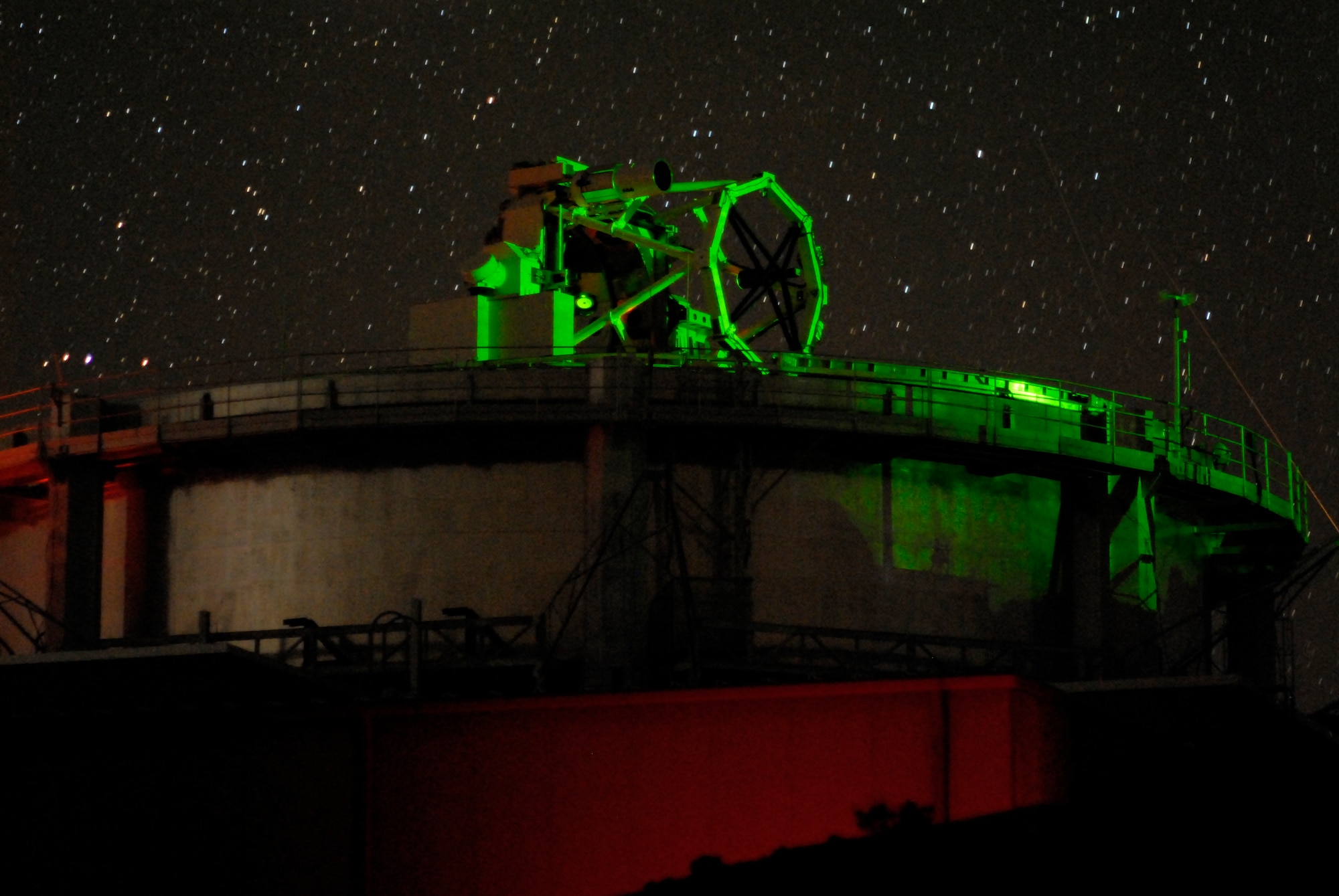 Air Force Research Laboratory’s 3.6-meter, 75-ton Advanced Electro-Optical System (AEOS) telescope under laser illumination at its Directed Energy Directorate’s Air Force Maui Optical and Surveillance Site, Maui, Hawaii.   The illumination resulted from the multi-wave length laser propagation experiments that were completed at over 10,000 feet and over a 90-mile path between Mauna Loa on the island of Hawaii and the Air Force site atop the extinct volcano, Haleakala, on Maui, Hawaii.      U.S. Air Force Photo by Rob Ratkowski                            