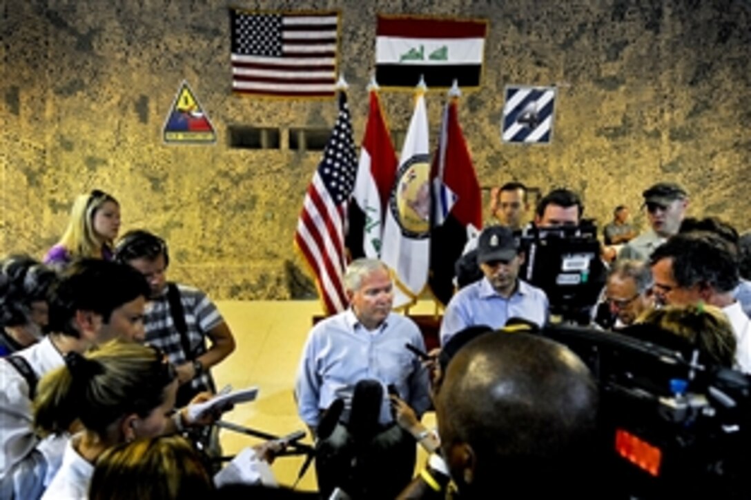 U.S. Defense Secretary Robert M. Gates talks with members of the traveling press after visiting  troops on Camp Ramadi, Iraq, Sept.1, 2010. Gates is visiting Iraq to mark the end of U.S. combat in the country.