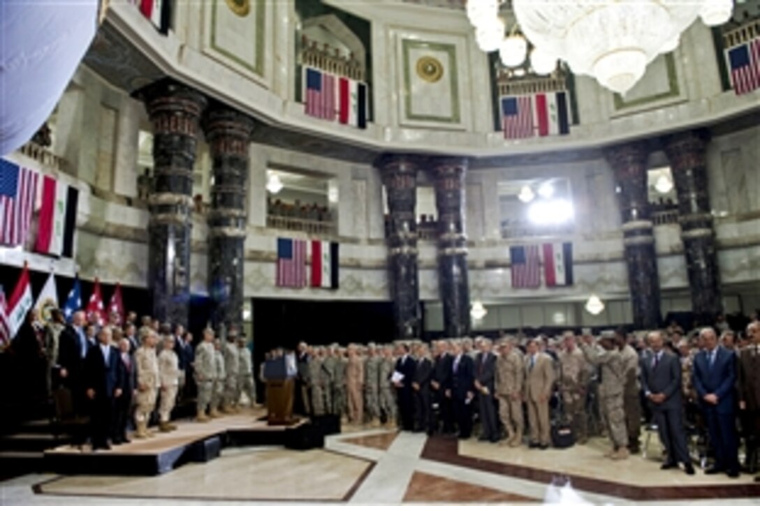 Audience members rise at the end of the change-of-command ceremony for U.S. Forces Iraq at al Faw Palace in Baghdad, Sept. 1, 2010. U.S. Army Gen. Lloyd J. Austin III relieved U.S. Army Gen. Raymond T. Odierno as commander of the remaining forces in Iraq, marking the end of U.S. combat operations in the country.