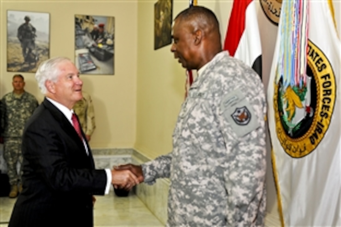 U.S. Defense Secretary Robert M. Gates congratulates U.S. Army Gen. Lloyd J. Austin III after promoting him just before he assumed command of U.S. Forces Iraq at the Al Faw Palace on Camp Victory, Iraq, Sept.1, 2010.