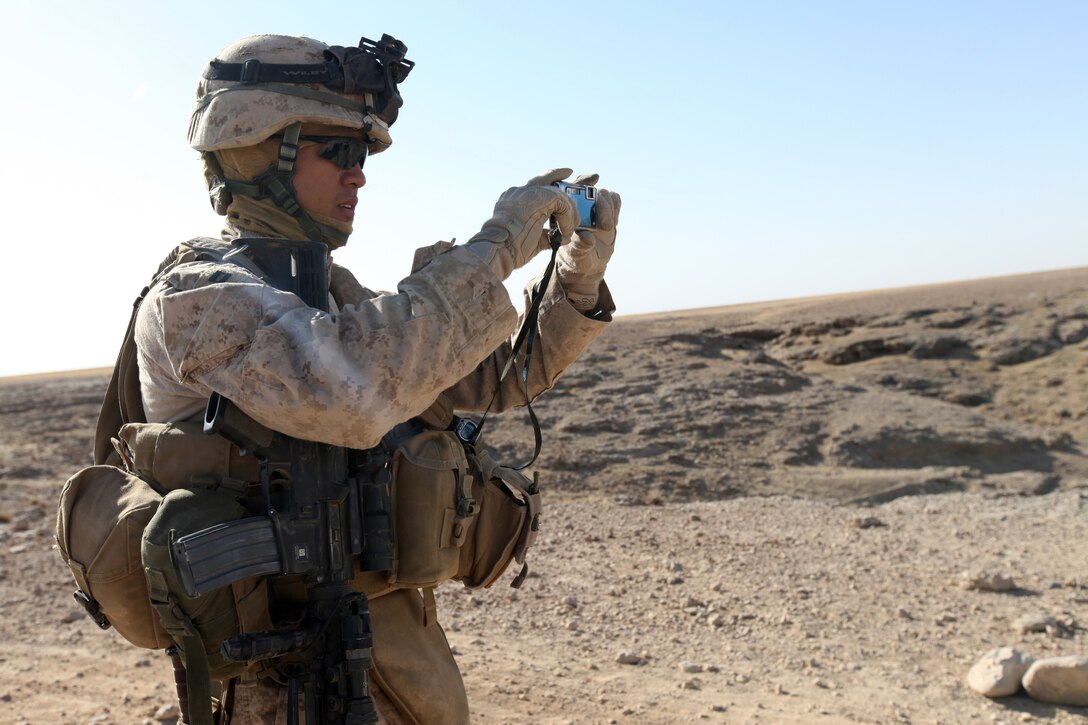 Capt. Tyrone A. Barrion, company commander for Bulk Fuel Company, 9th Engineer Support Battalion, 1st Marine Logistics Group (Forward), takes photos of the landscape of a possible route for future missions during a route reconnaissance mission in Helmand province, Afghanistan, Sept. 1. ‘The most important thing for us is to be able to have options during a mission,’ said Barrion, 26, from San Diego. ‘The more options we have of which route to take, the more work the enemy has to do to hit us, which provides us a safer and faster passage to resupply our friendly units.’