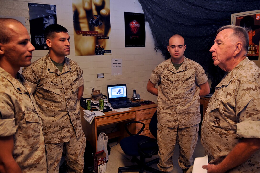 Lt. James Finley, Catholic chaplain for the Marine Corps Air Station in Yuma, Ariz., talks to three Marines with Marine Unmanned Aerial Vehicle Squadron 4 during his daily visits to different units on station Sept. 1, 2010. The 73-year-old New York City-native is the oldest sailor in the service, with 47 years in the priesthood, 20 of it as a Navy chaplain.