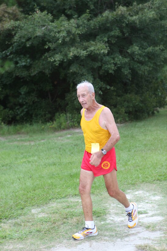 Retired Sgt. Maj. Domenick Irrera, a race participant, runs toward the finish line during the Marine Corps Community Services’ 5K Labor Day Fun Run aboard Marine Corps Base Camp Lejeune, Sept. 2.  Irrera and other retired military veterans gathered together with service members, families, Department of Defense civilians and a dog to complete the three-mile course.