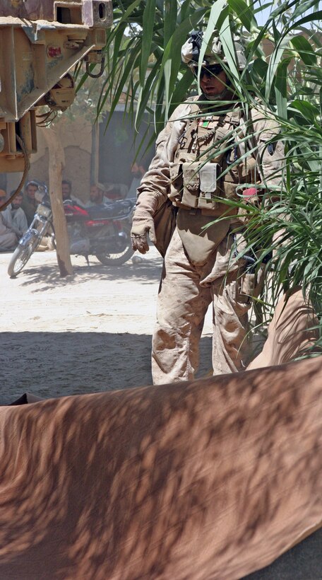 A Marine with 2nd Battalion, 9th Marines, examines new carpet for Yellow School, Sept. 02, in Marjah. Yellow School is one of the many community restoration projects 3rd Civil Affairs Group, 2/9 has accomplished. The unit is preparing for the opening day of school later in the week, posting security and ensuring all students have the essential school supplies.