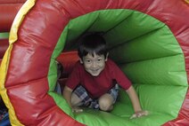 Daniel, son of Col. Mark Kling from the Pacific Air forces inspector generals office, crawls through an air tunnel during the Mahalo Bash Sept. 2, 2010, at Joint Base Pearl Harbor-Hickam. The Mahalo Bash is an annual event hosted by the PACAF commander to thank Airmen and their families for their service and hard work throughout the year. (U.S. Air Force photo/Tech. Sgt. Matthew McGovern)