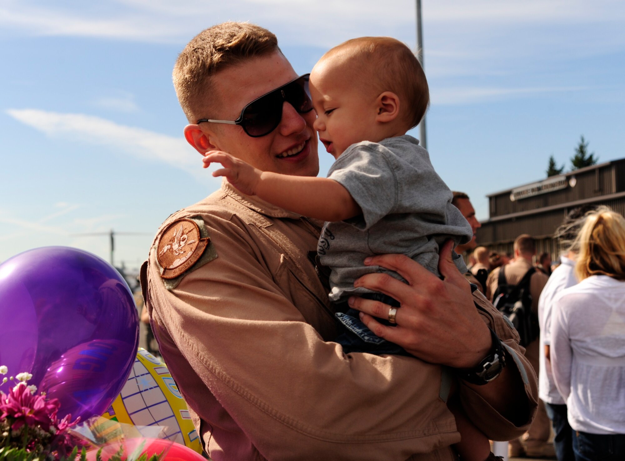Capt. Chris Bohner, assigned to the 8th Airlift Squadron, holds his son after coming home from a deployment Sept. 2 at Joint Base Lewis-McChord, Wash. (U.S. Air Force photo/Airman Leah Young)