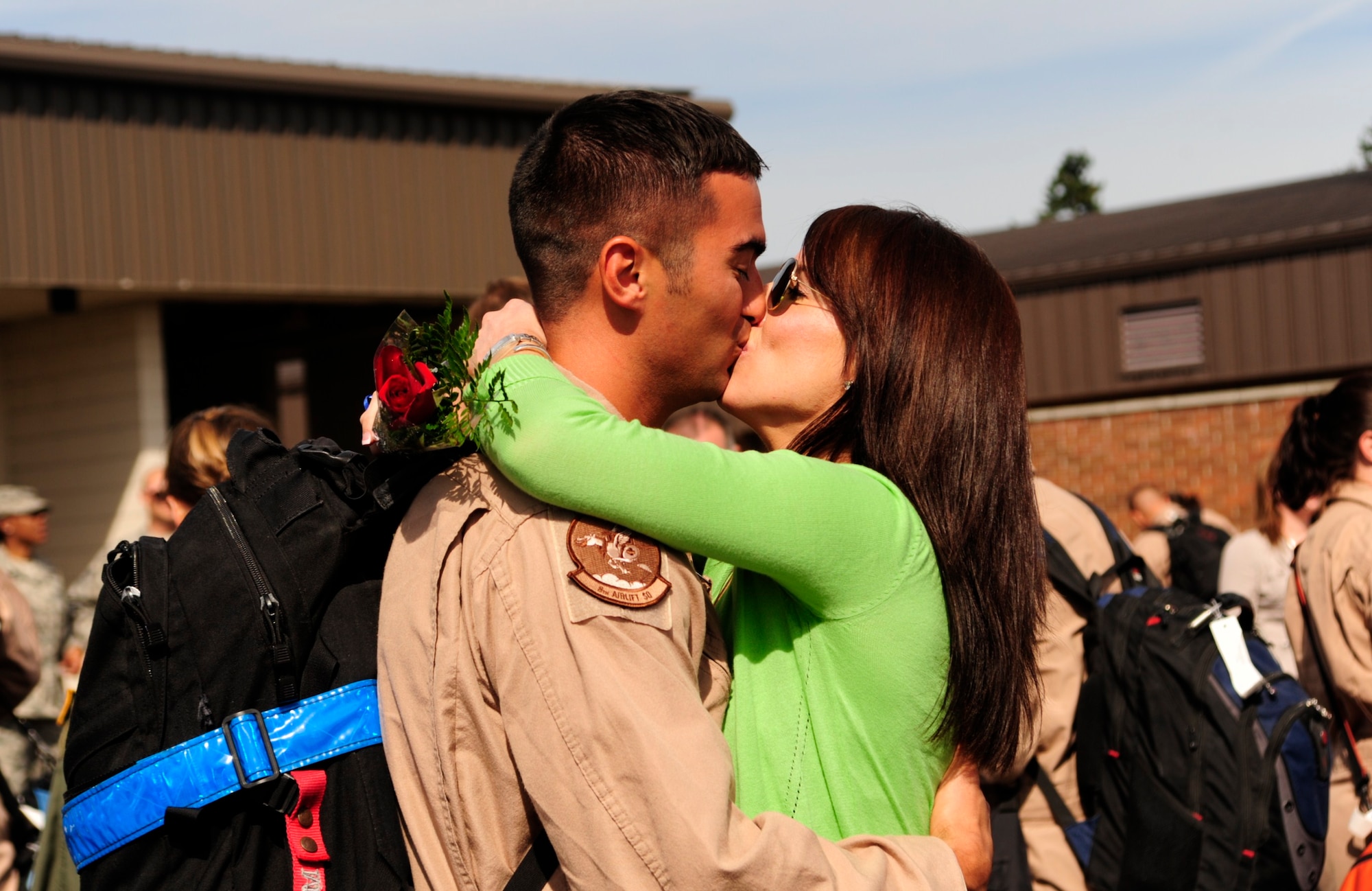 An Airman assigned to the 8th Airlift Squadron gives his wife a kiss after returning home from a four-month deployment Sept. 2 at Joint Base Lewis-McChord, Wash. (U.S. Air Force photo/Airman Leah Young)