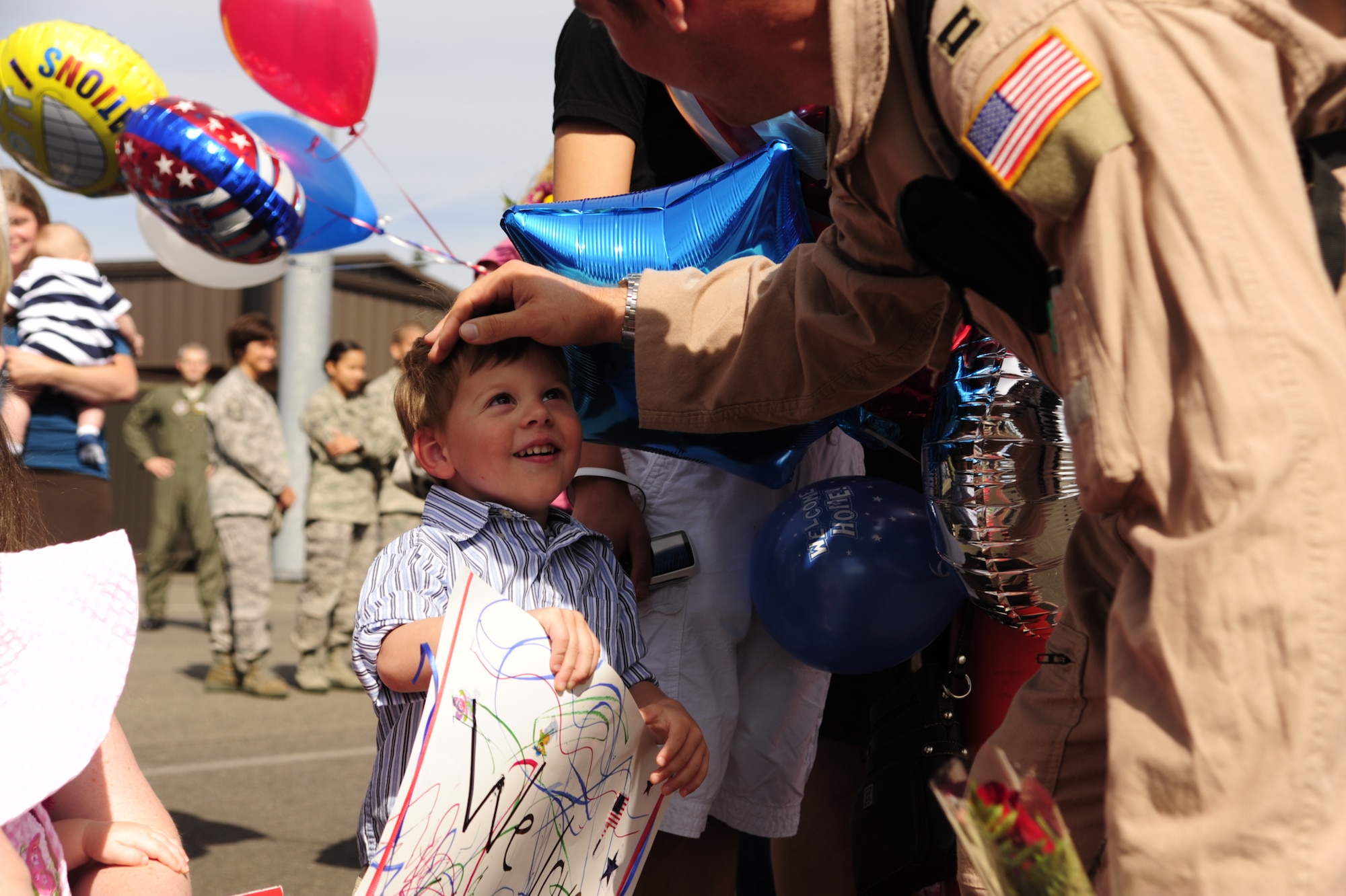 The son of an Airman assigned to the 8th Airlift Squadron smiles at his father soon after he returned from a four-month deployment Sept. 2 at Joint Base Lewis-McChord, Wash. (U.S. Air Force photo/Airman Leah Young)