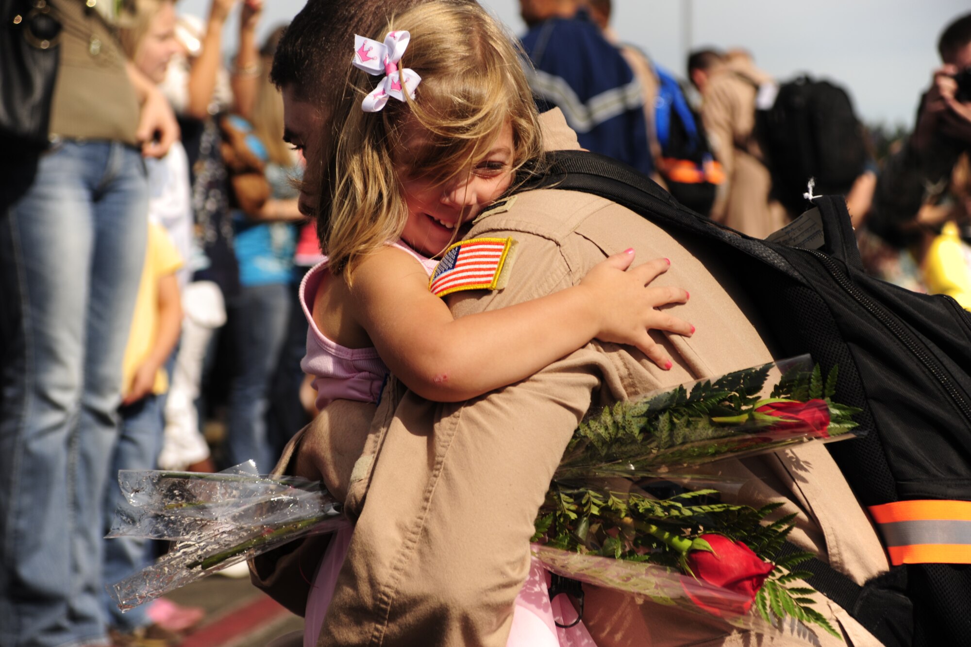 1st Lt. Evan Nickel, 8th Airlift Squadron pilot, embraces his daughter after returning home from a four-month deployment Sept. 2 at Joint Base Lewis-McChord, Wash. (U.S. Air Force photo/Airman Leah Young)