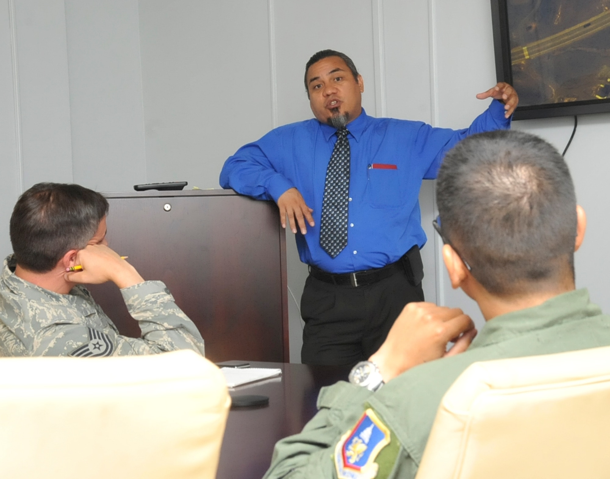 JOINT BASE ANDREWS, Md. -- Randolph Sena, 316th Wing chief of exercises, plans and inspections, delivers a briefing to military exercise evaluators, prior to a base-wide exercise simulating a munitions accident. Mr. Sena served in the Air Force for 20 years. (U.S. photo by Bobby Jones)