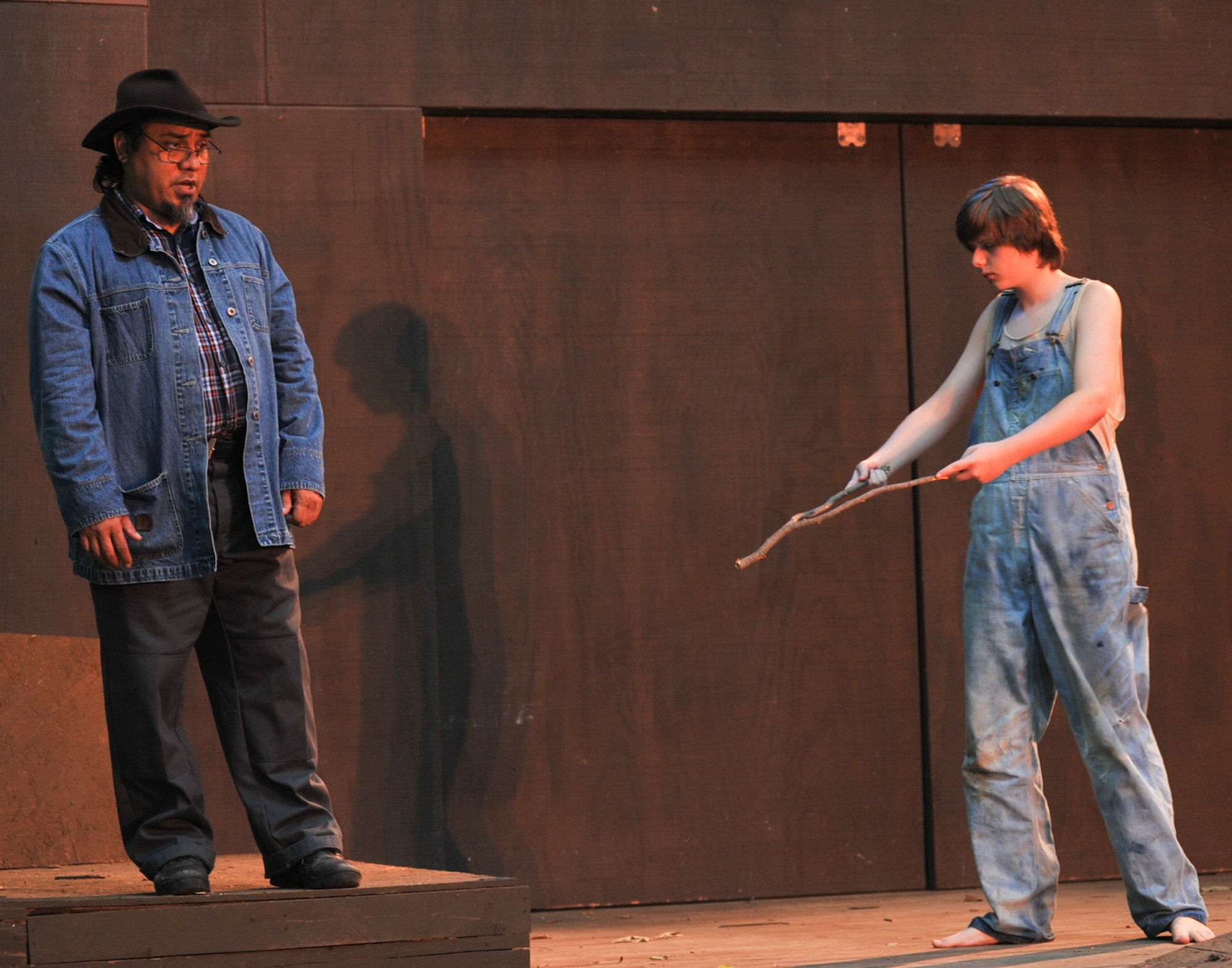 JOINT BASE ANDREWS, Md. -- During a scene from ‘The Diviners,’Randolph Sena portrays ‘Basil Bennett,’ an easy going, philosophical farmer, who casually observes as ’Buddy,’ an emotionally disturbed young man, uses a divining rod to locate water during a lengthy drought. (U.S. Air Force photo by Bobby Jones)