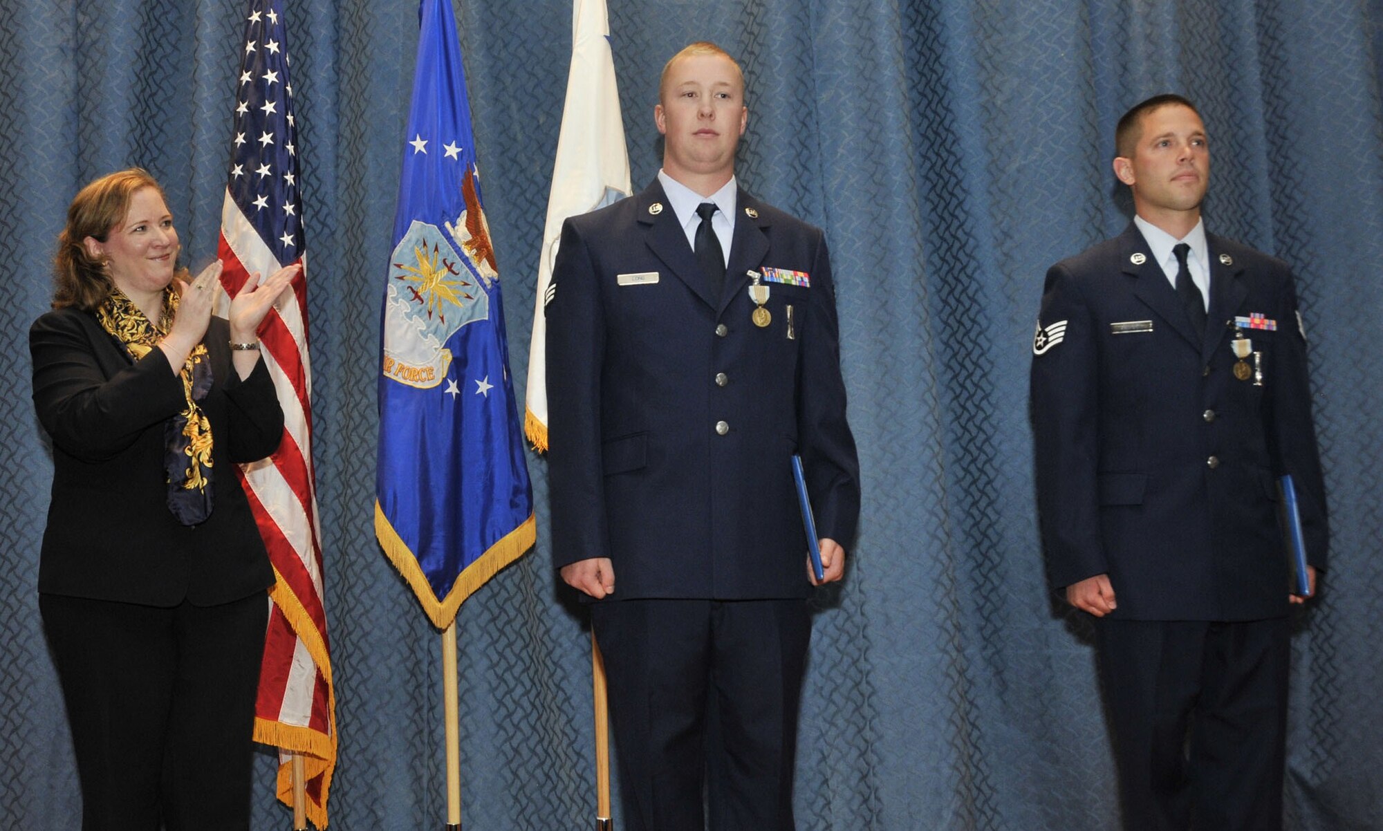 MALMSTROM AIR FORCE BASE, Mont. - Under Secretary of the Air Force Erin C. Conaton leads the audience in a round of applause Aug. 26 after she presented Senior Airman Kyle Long and Staff Sgt. Christopher Zachary, both from the 341st Missile Maintenance Squadron, with an Airman's Medal. The Air Force Global Strike Command Airmen were recognized for their heroic efforts and role in saving an accident victim from a burning vehicle. (U.S.Air Force photo/Beau Wade)