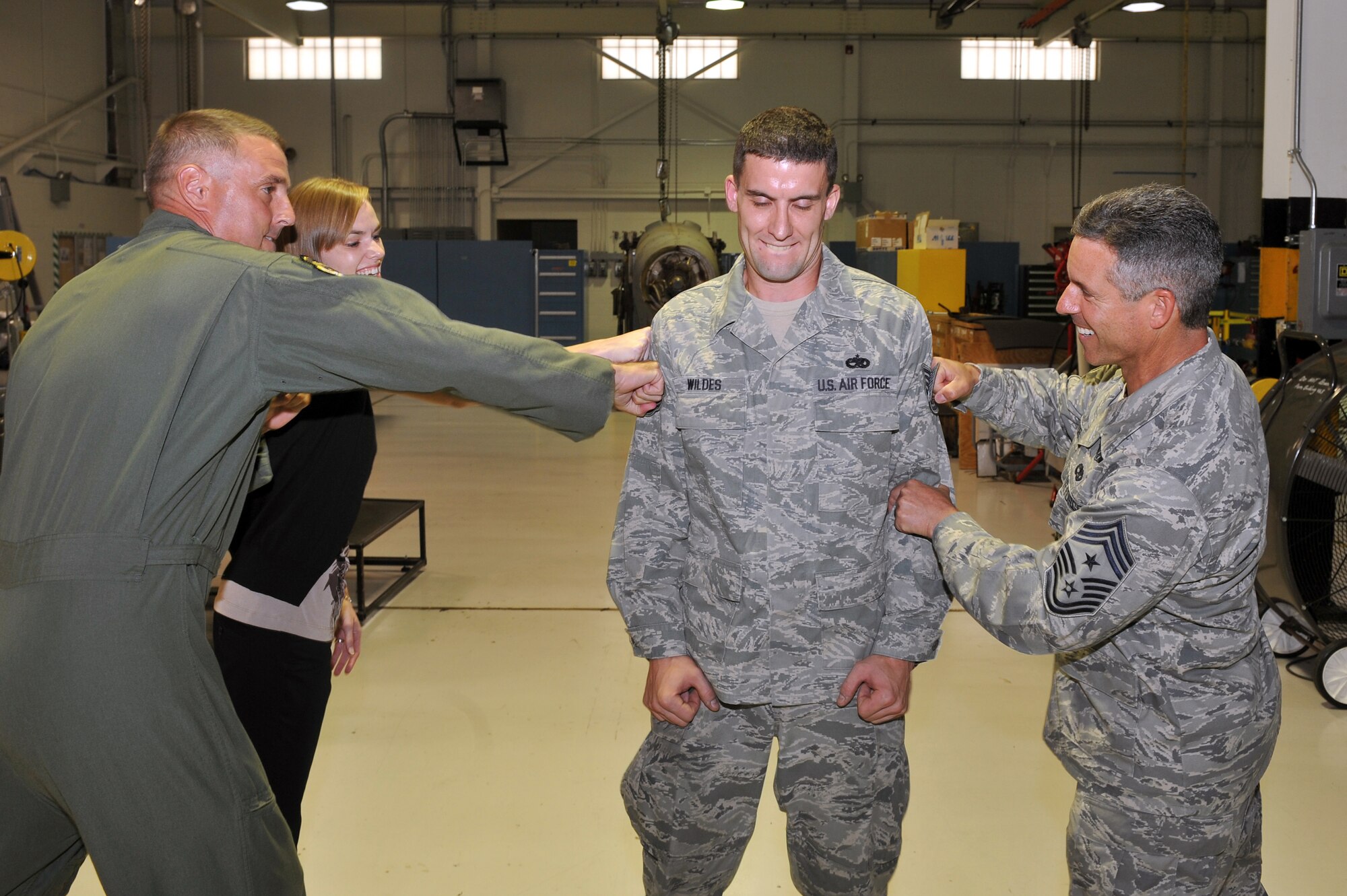 LITTLE ROCK AIR FORCE BASE, Ark -- Staff Sgt. Andrew Wildes, 19th Component Maintenance Squadron aerospace propulsion craftsman, poses for a photo with Chief Master Sgt. David Spector, Air Mobility Command command chief master sergeant, his wife, Jessica, and Col. Michael Minihan, 19th Airlift Wing commander, after he was promoted to technical sergeant through the Stripes for Exceptional Performers program.  (U.S. Air Force photo by Staff Sgt. Chris Willis)