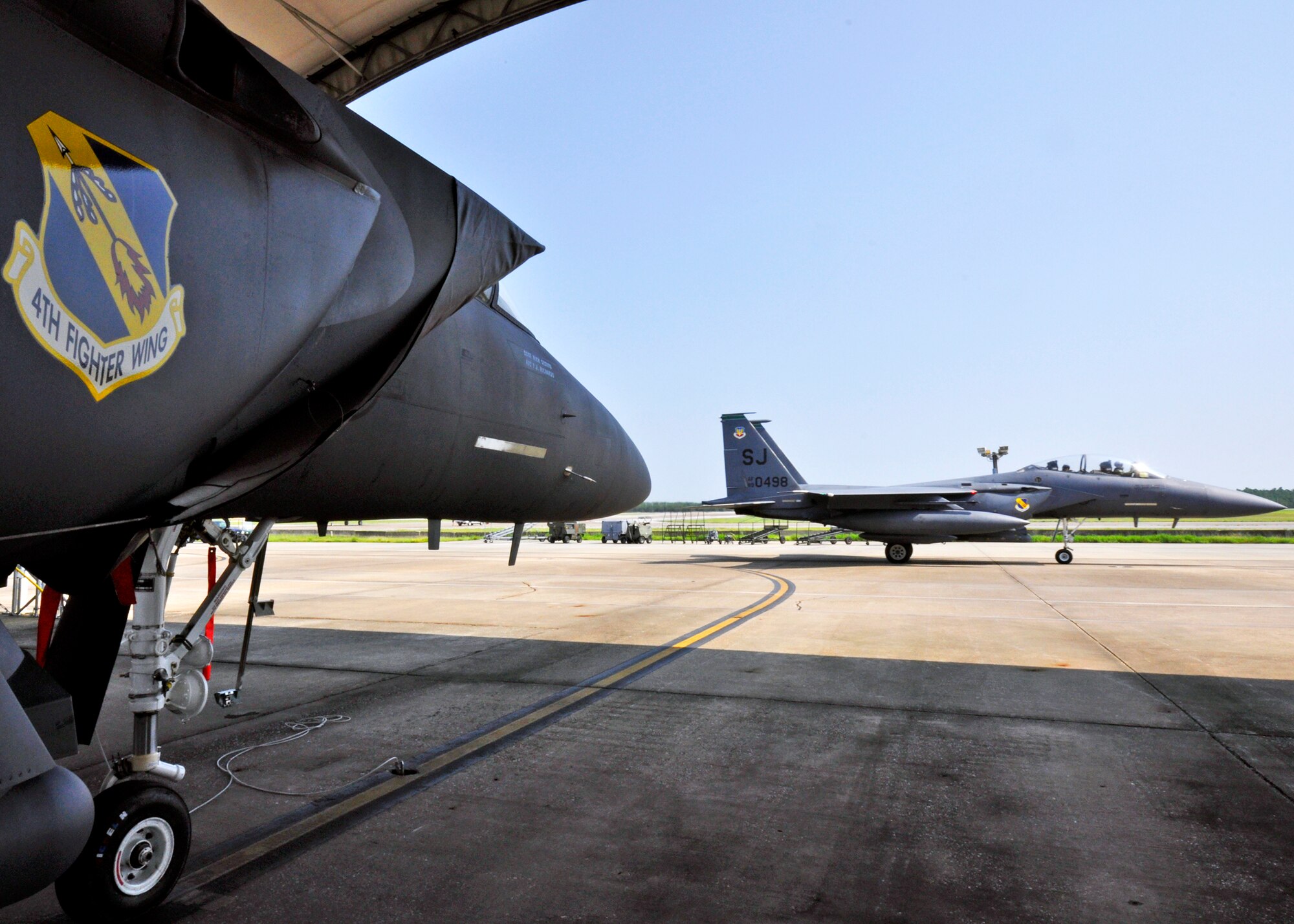 A 4th Fighter Wing F-15E Strike Eagle sits as another arrives to Eglin Air Force Base, Fla., as part of a hurricane evacuation from Seymour Johnson AFB, N.C., Sept. 2  Approximately 30 Strike Eagles, three KC-135 Stratotankers and 300 personnel arrived to beddown the aircraft as Hurricane Earl headed for the N.C. coast.  The 33rd Fighter Wing, a former F-15 unit now the training wing for the F-35 Lightning II, provided flightline space for the aircraft.  (U.S. Air Force photo/Samuel King Jr.)