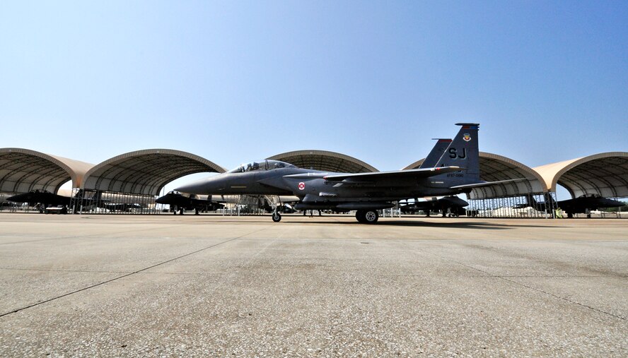 A 4th Fighter Wing F-15E Strike Eagle passes by others that arrived to Eglin Air Force Base, Fla., as part of a hurricane evacuation from Seymour Johnson AFB, N.C., Sept. 2.  Approximately 30 Strike Eagles, three KC-135 Stratotankers and 300 personnel arrived to beddown the aircraft as Hurricane Earl headed for the N.C. coast.  The 33rd Fighter Wing, a former F-15 unit now the training wing for the F-35 Lightning II, provided flightline space for the aircraft.  (U.S. Air Force photo/Samuel King Jr.)