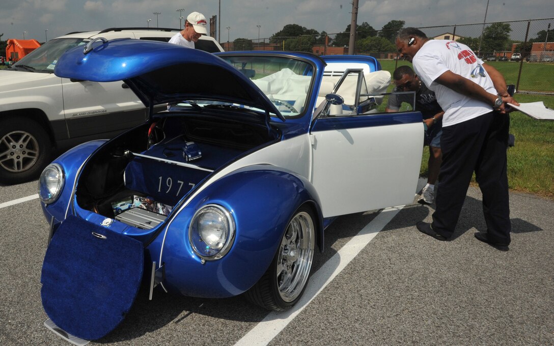 JOINT BASE ANDREWS, Md. -- Phillip Camp, car show judge, left, examines the exterior body of a 1977 Volkswagen ‘Super Beetle’ as fellow car show judge, Ron Ramuser, examines the interior passenger compartment during an Annual Joint Base Andrews Auto Hobby Shop Car Show in parking lot across from the Outdoor Recreation facility Aug. 28.  The year categories represented included domestic: 2000 to present, 1977-1999, 1976 and back.  The oldest vehicle was a vintage 1932 Hudson. Among some of the rare vehicles was a 1938 Speedwagon, two Viper SRT Trucks and a Nissan Skyline, an import sportscar. (U.S. Air Force photo by Bobby Jones)